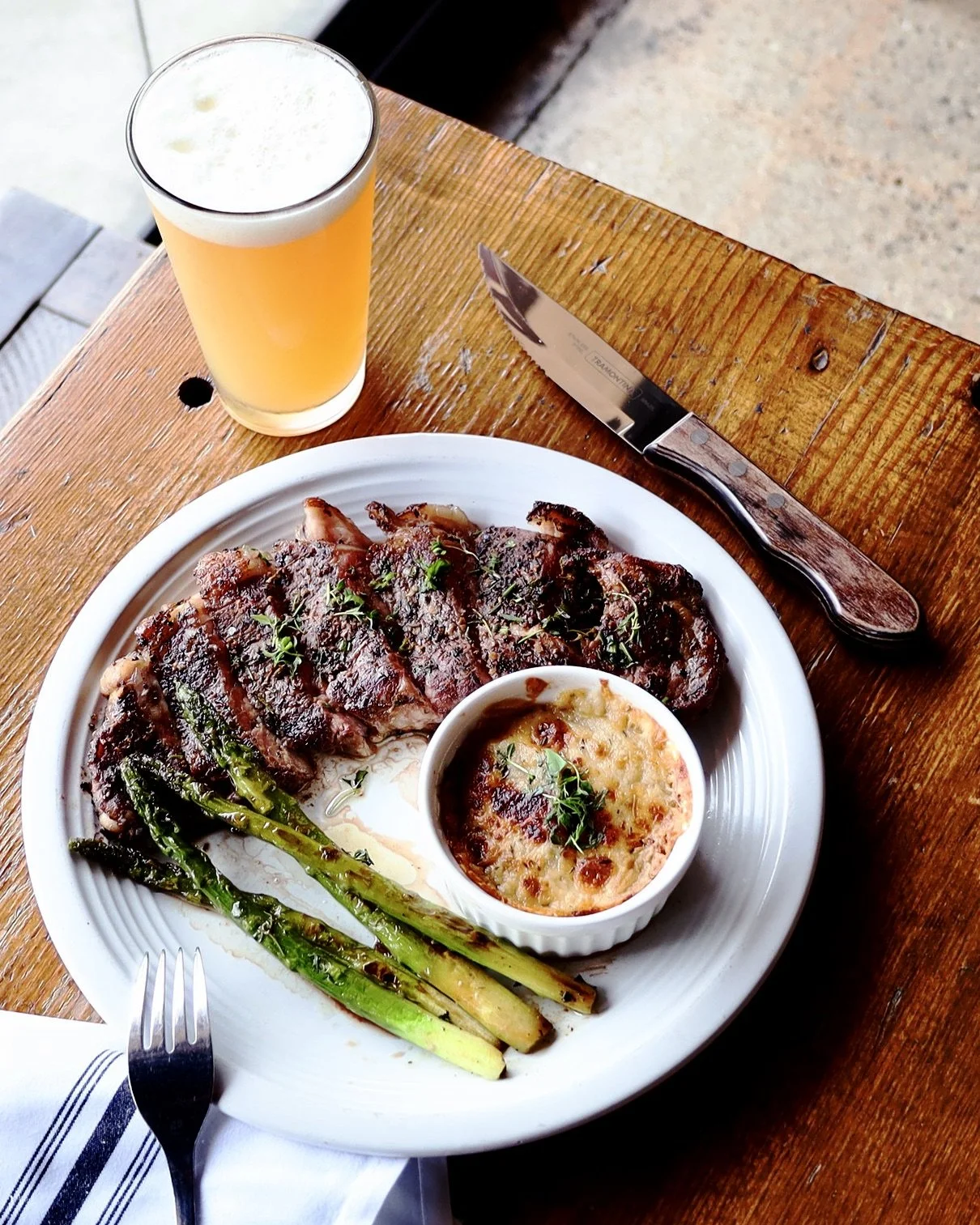 Herb Crusted NY Strip Steak with Roasted Asparagus and Cheesy Scalloped Potatoes.