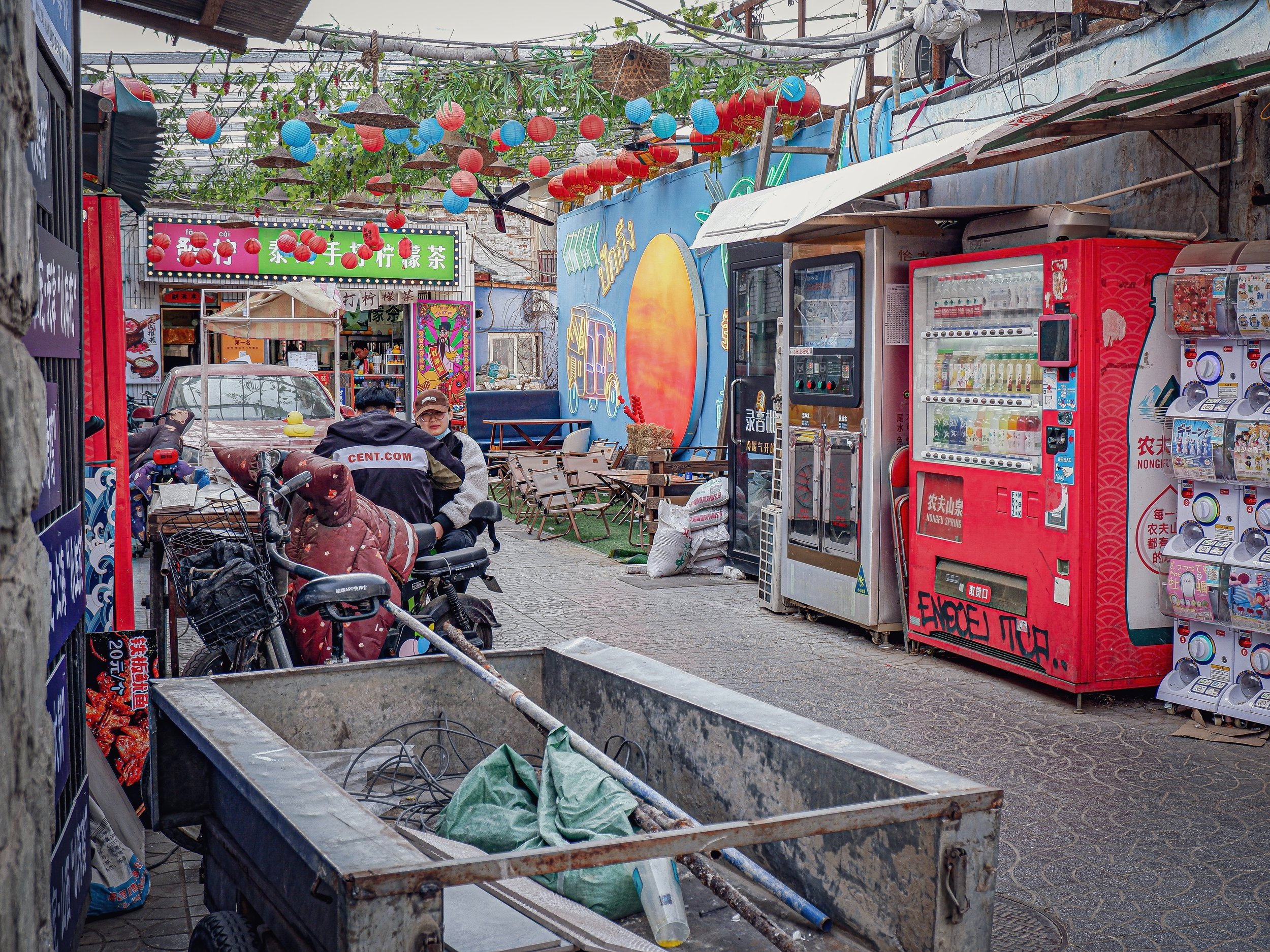 A couple grabs a snack in the hutong.