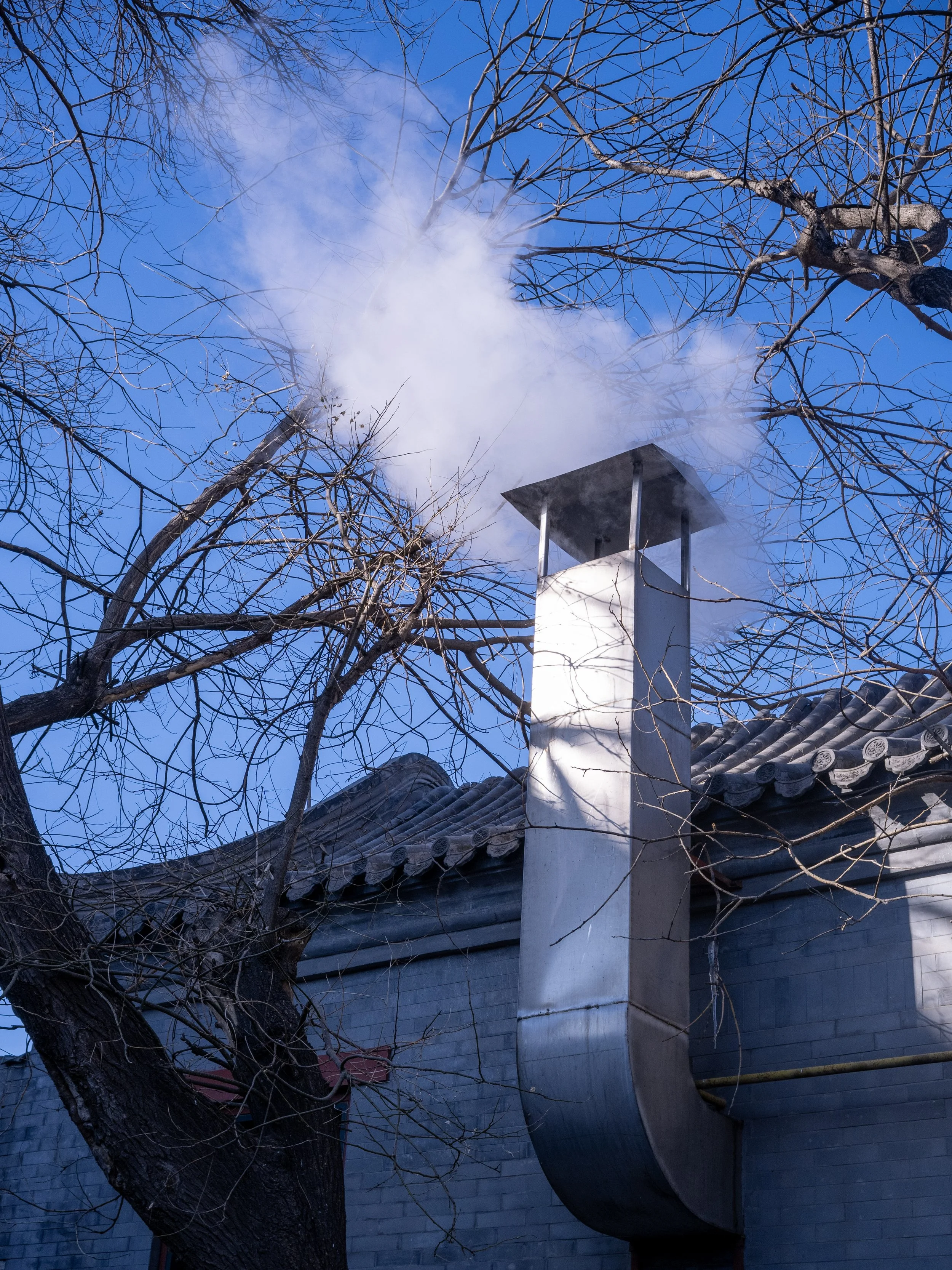 A metal chimney in the hutong.