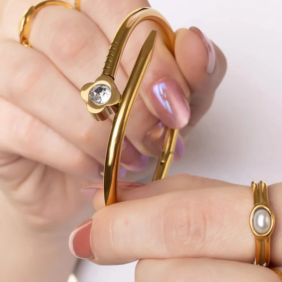 BRJ1119_18K-Gold-PVD_Floral_Nail_With_Stone_Bangle_MODEL-2048x2048_5a2fe1f6-df5f-467a-bf35-012cb710640f.jpg