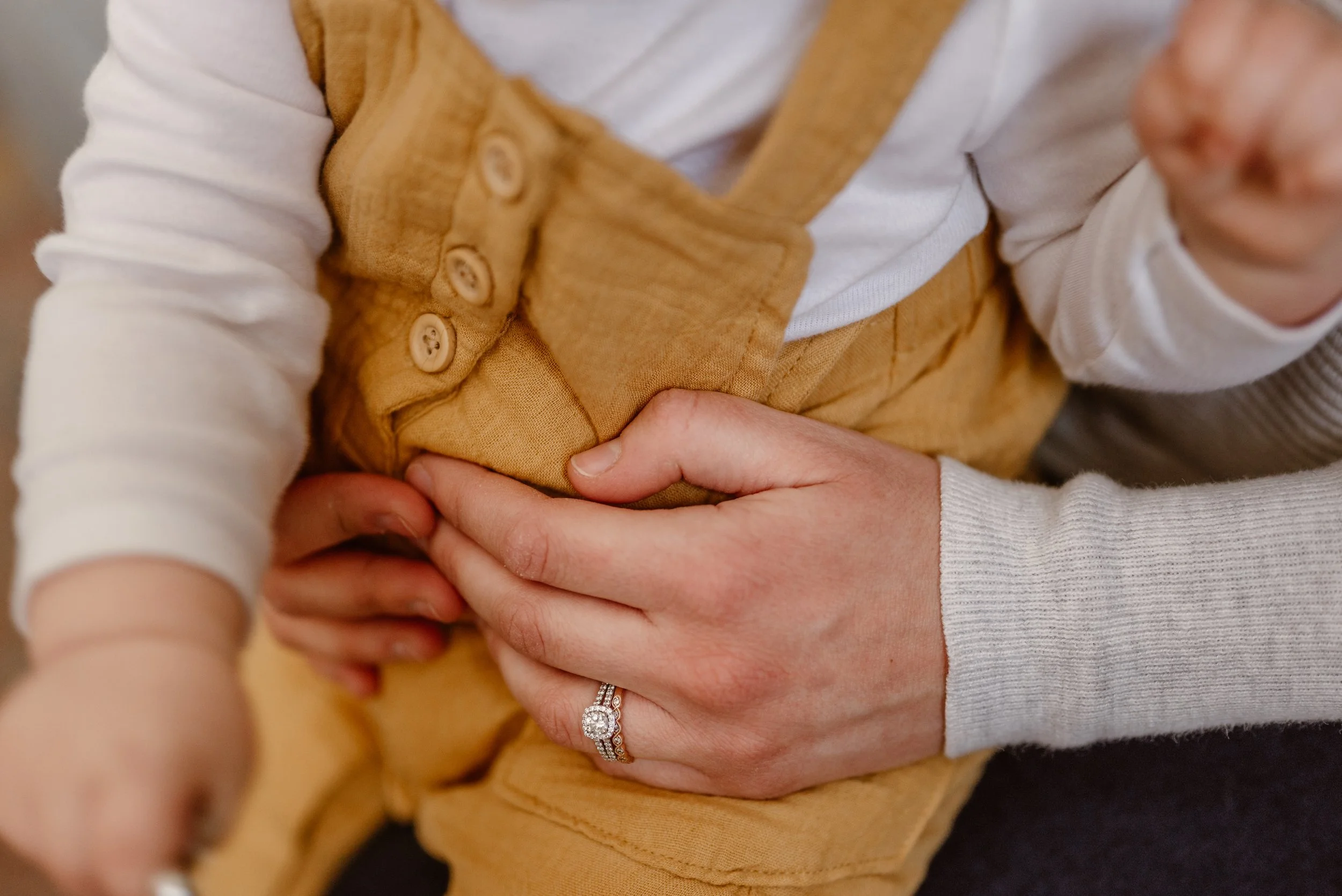 A mom holds her baby during a family lifestyle photoshoot