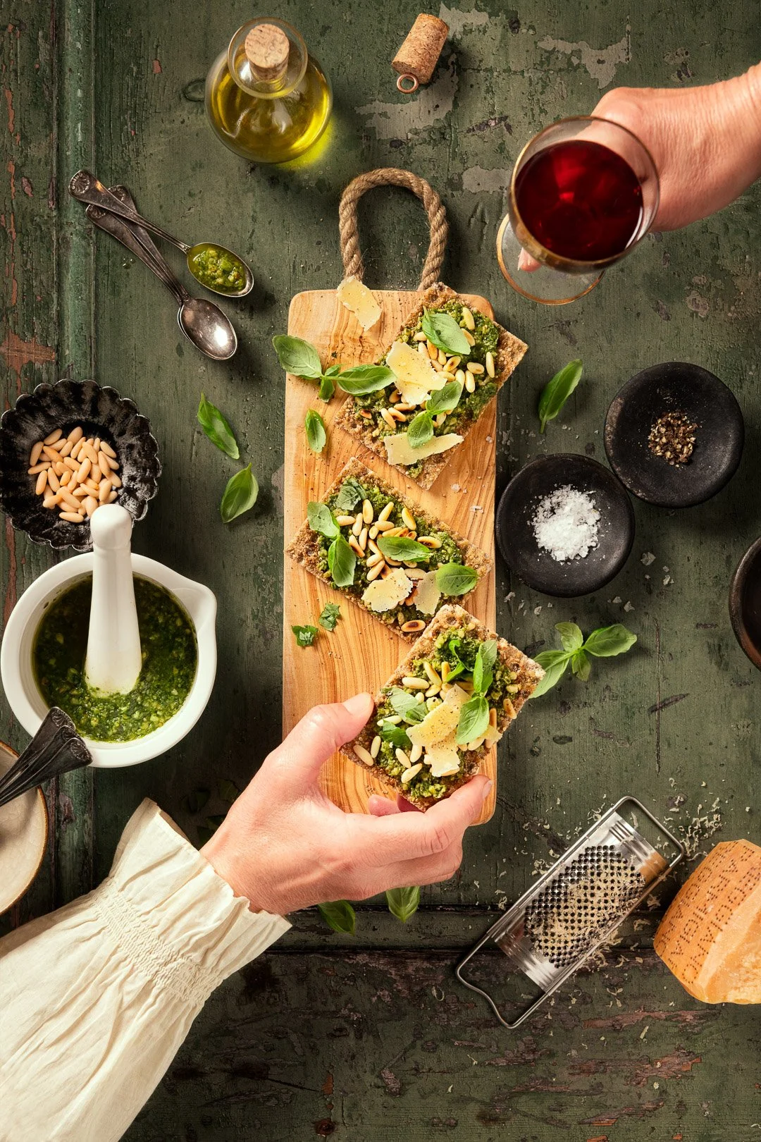 crispbread, pesto, snack, hands, wine glass, pine nuts, basil