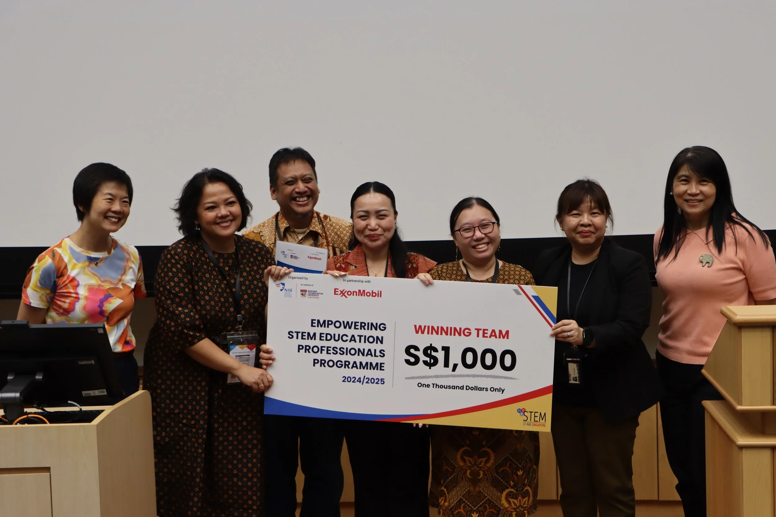 Winning team from PENABUR Intercultural School receiving their winning cheque from A/P Teo, A/P Tan and Ms. Karen Wong.