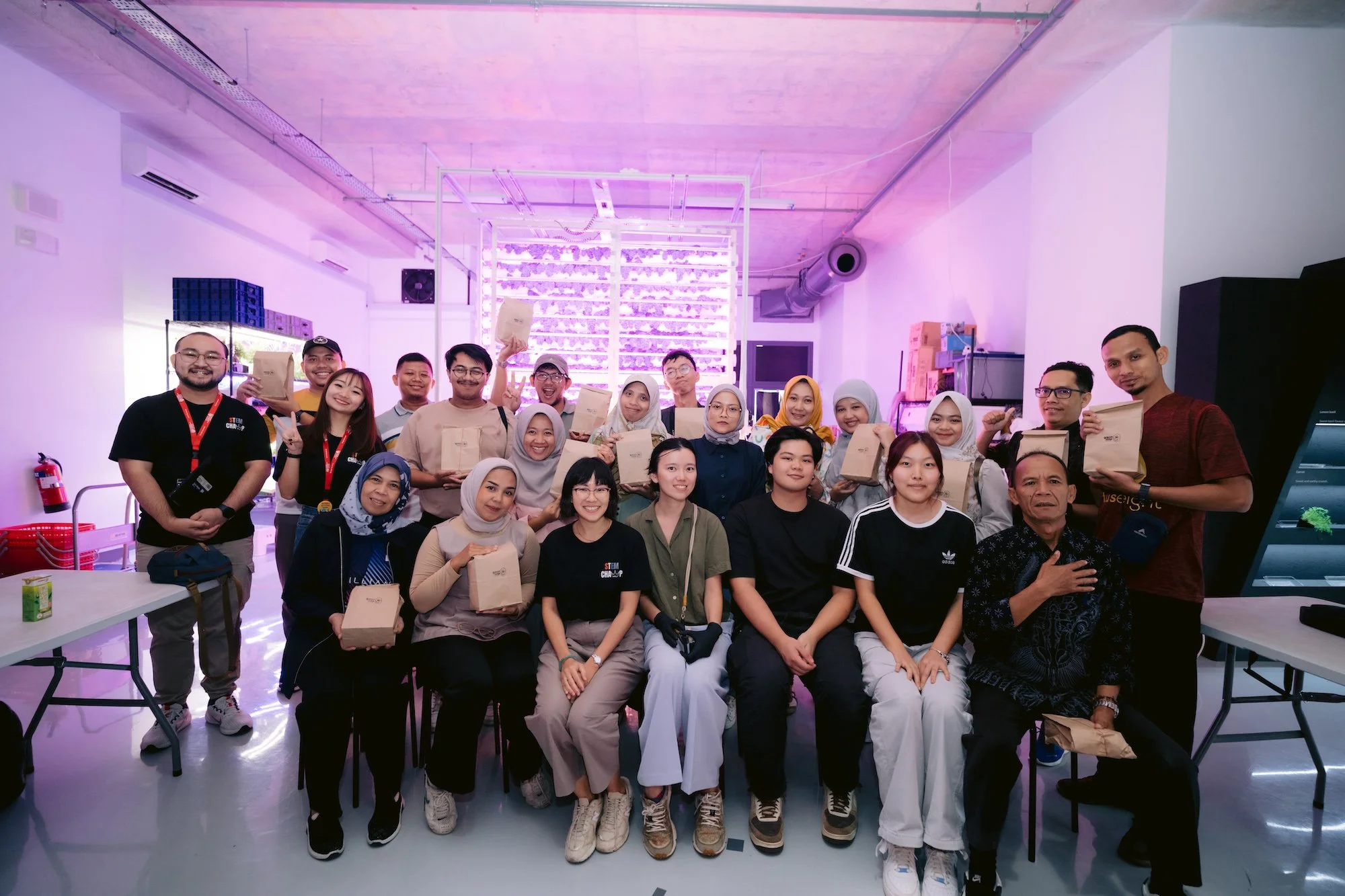 Group picture of the participants and instructors with their micro-green harvest