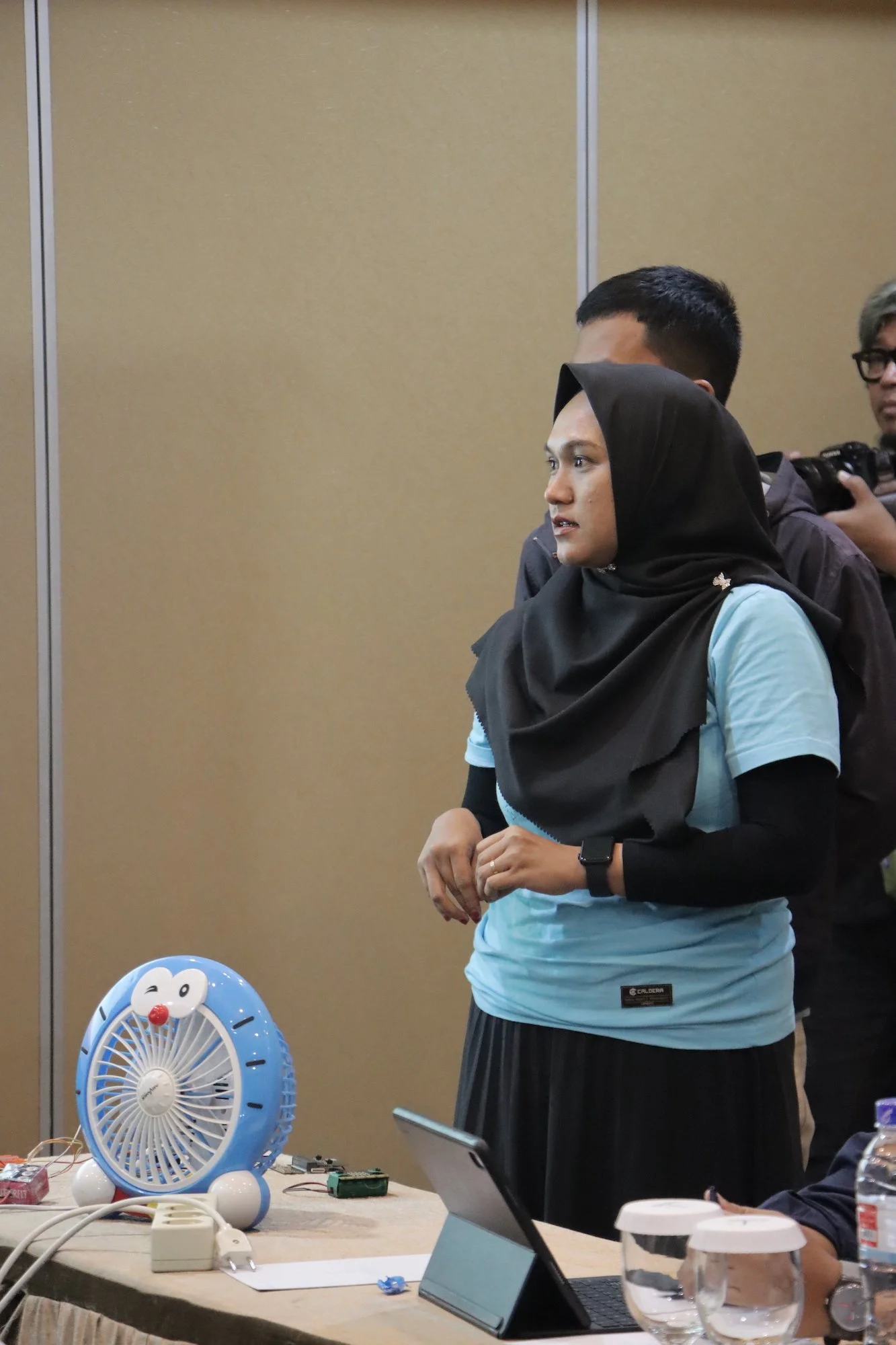  SMAN 7 Tanjung Pinang presenting their indoor fan shutdown detector that powers off fans in unoccupied areas, conserving energy   