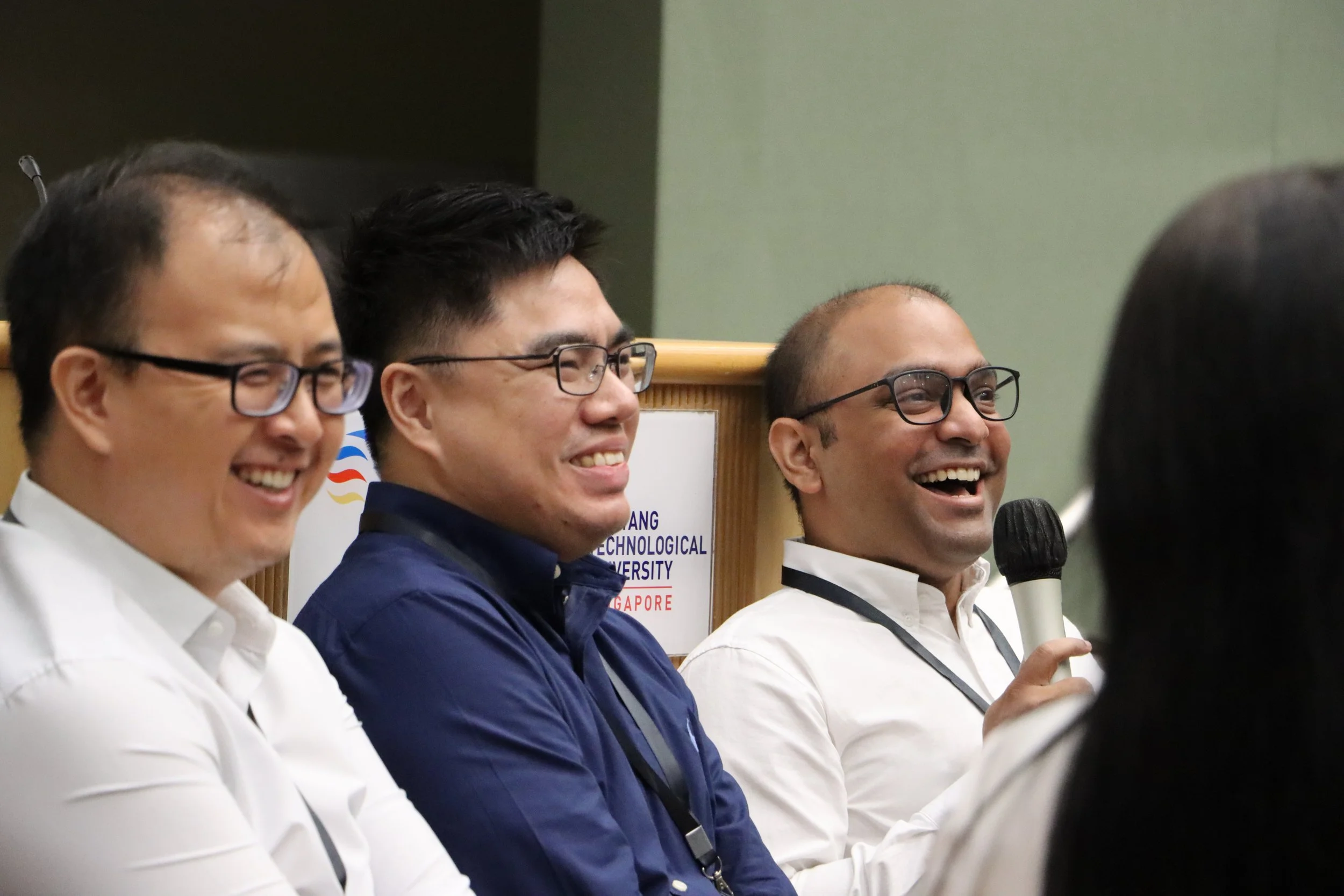 A moment of laughter captured as Mr Chan, Dr Lim, and Dr Ramachandra engage and speak candidly with the teacher participants.