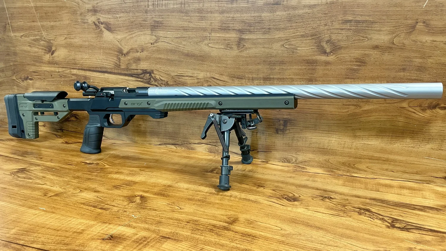 Scoped rifle with a stainless barrel and bipod, pictured at True-Flite