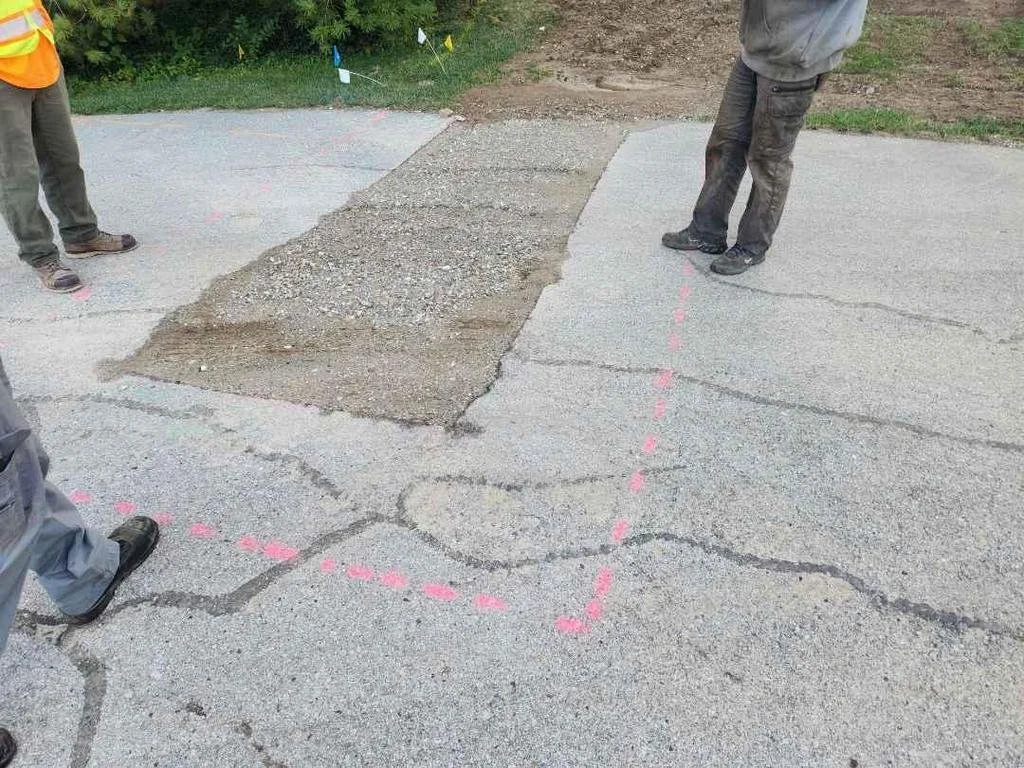 st ann street with broken asphalt that was excavated, exposing the sub base underneath.