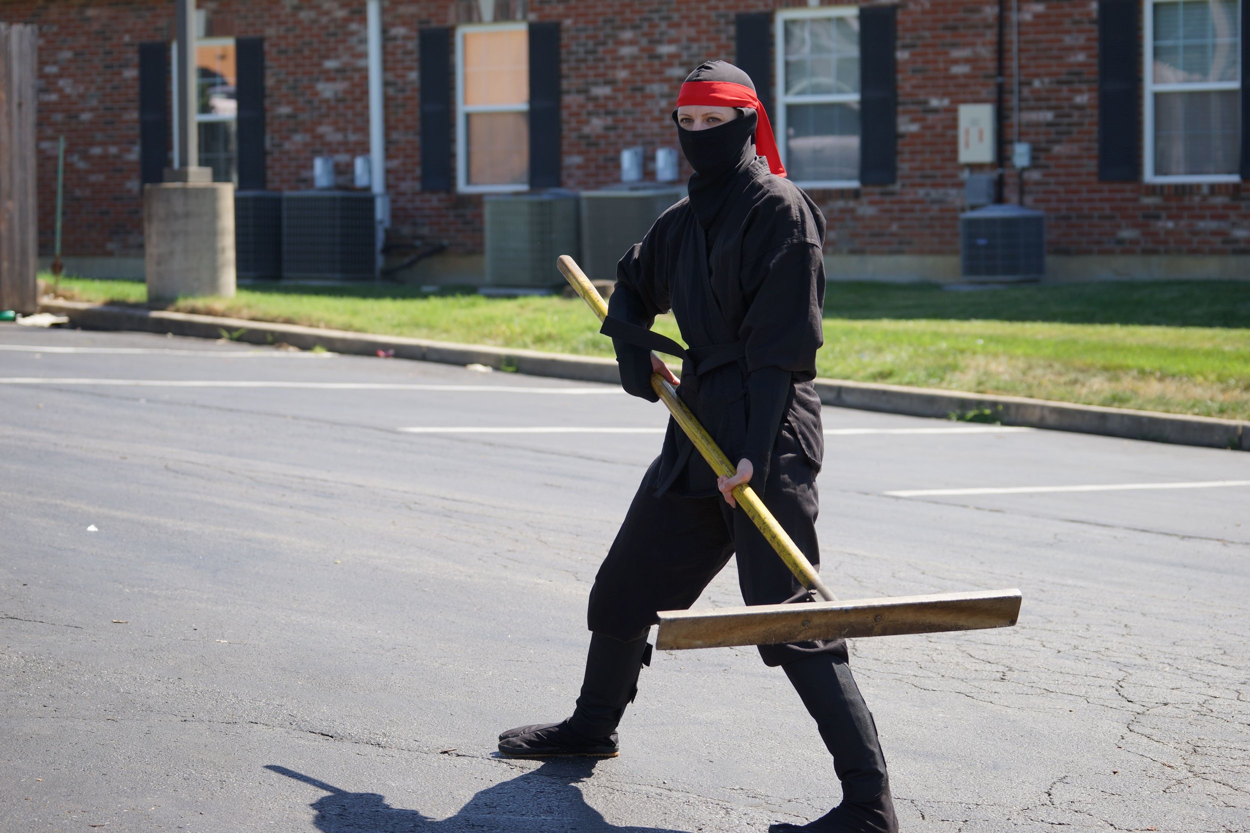 Asphalt Ninjas Owner dressed as a ninja holding a lute