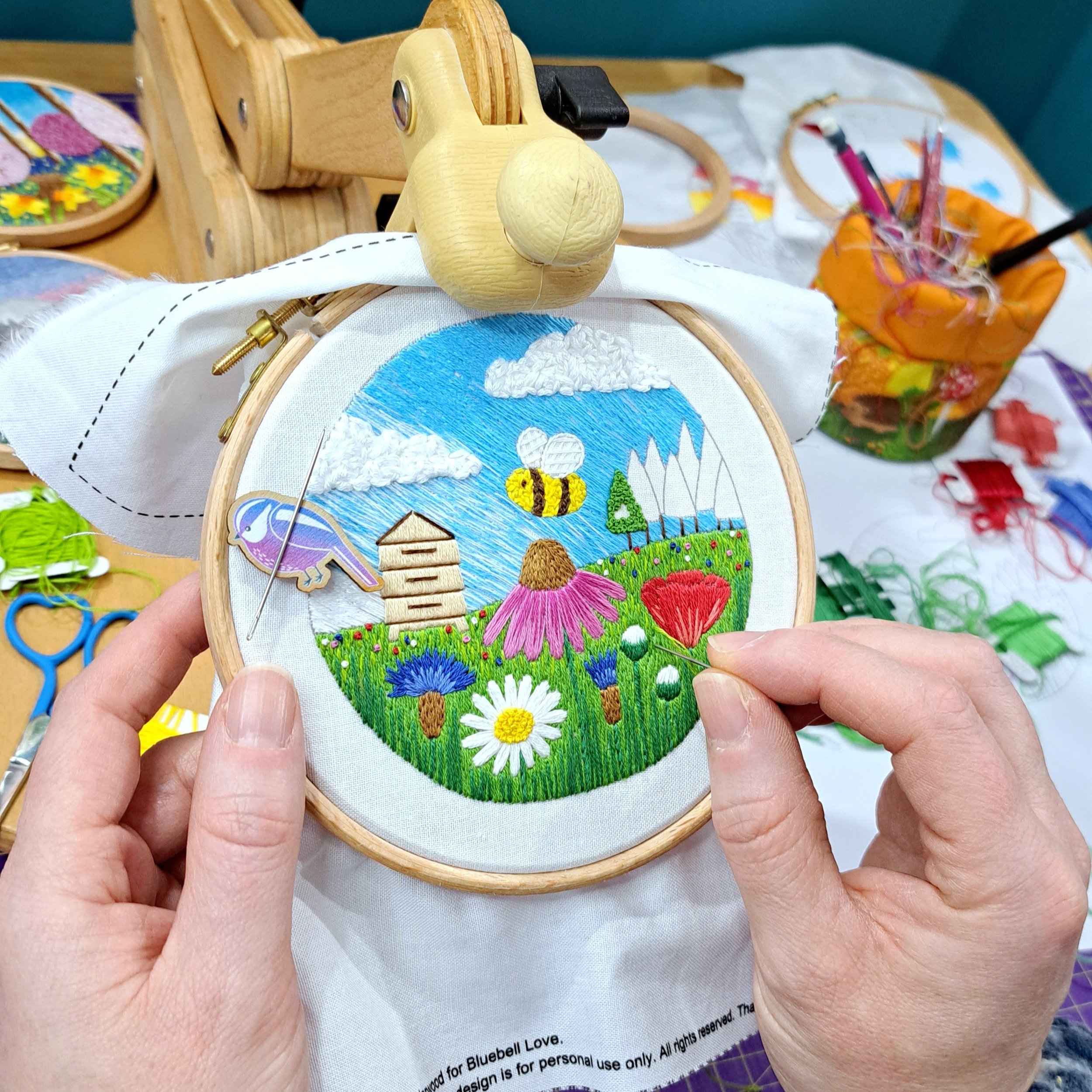 Liz stitching an embroidery project by hand