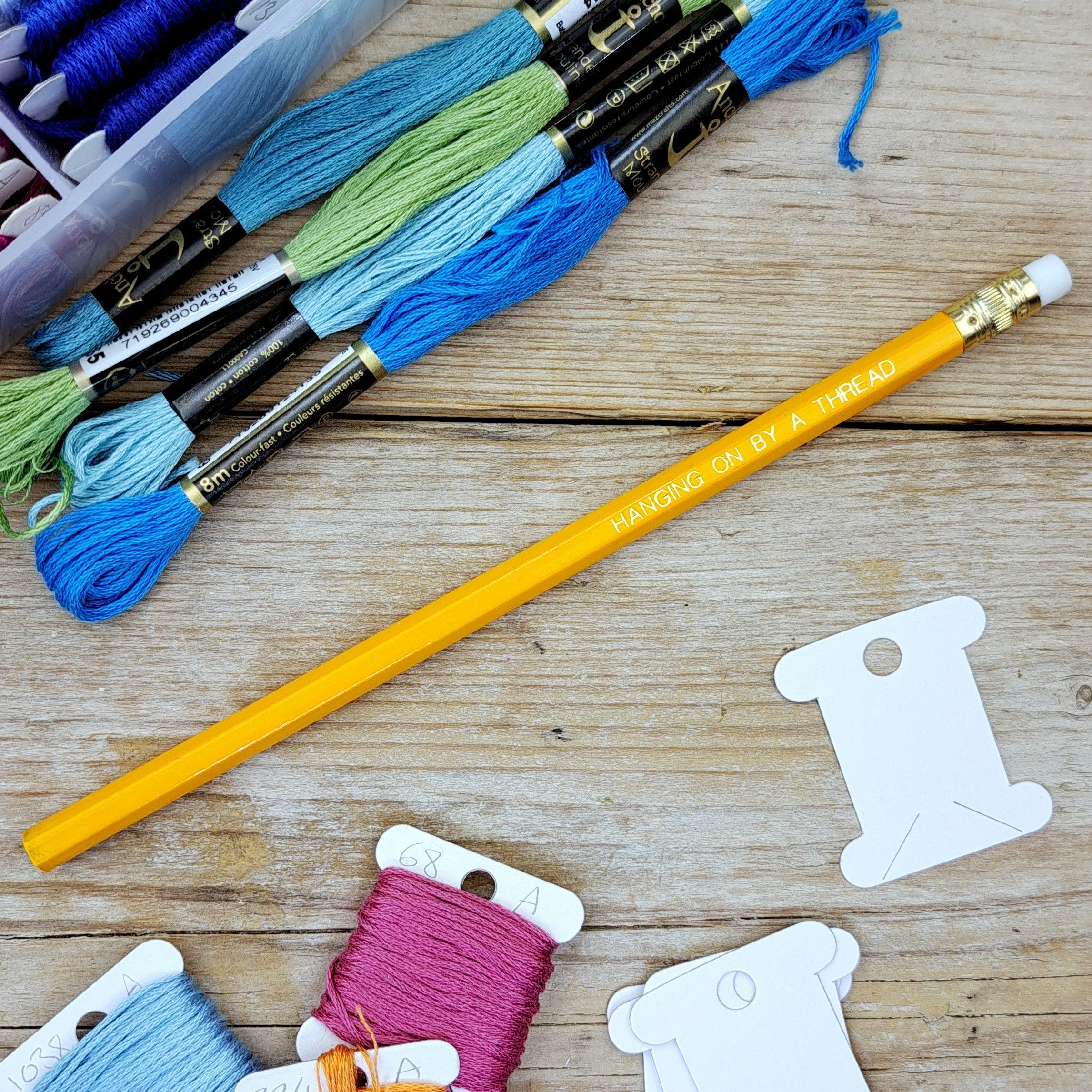 Full-length orange "Hanging on by a Thread" HB pencil with unsharpened graphite tip