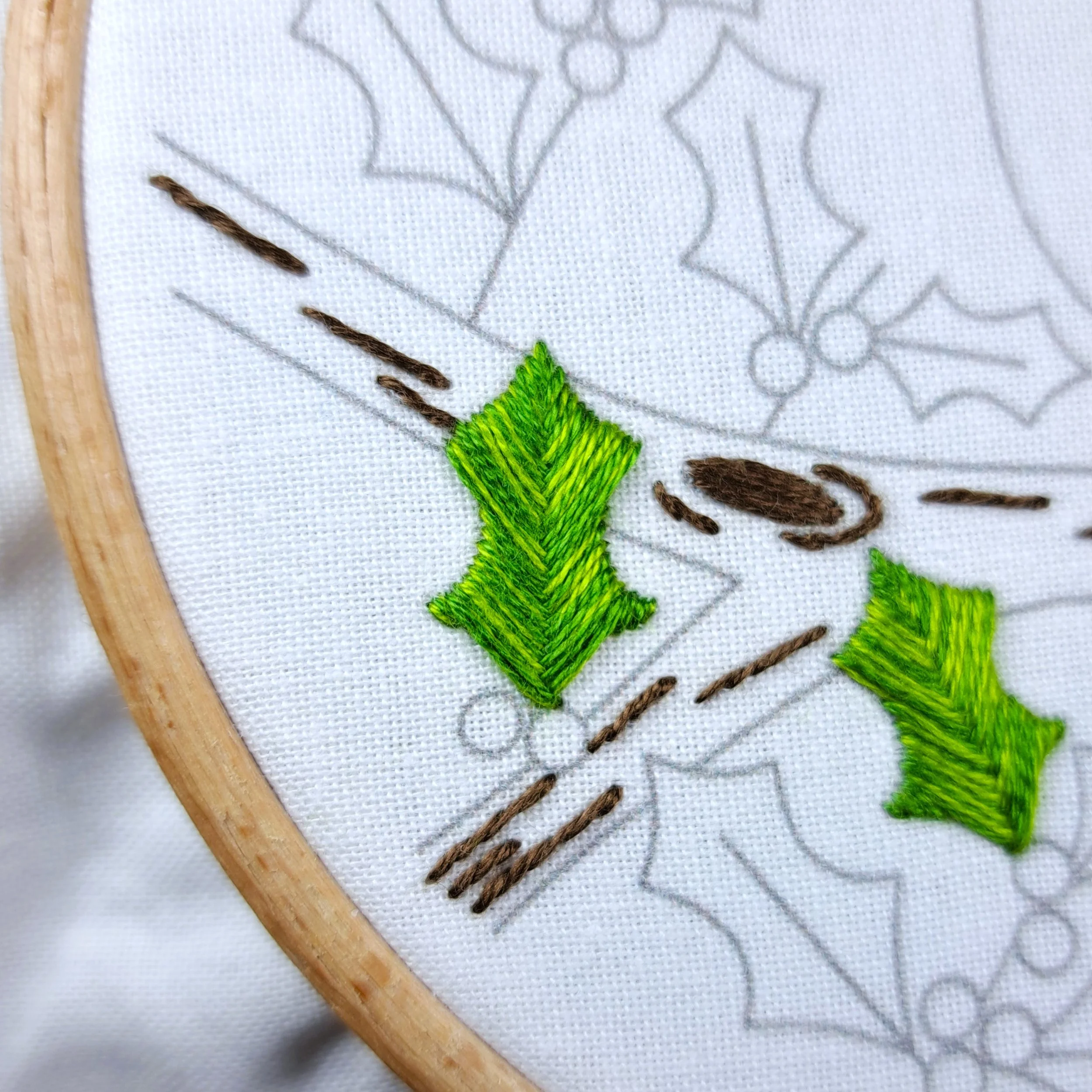 Close-up of a fully stitched holly leaf with green Fishbone Stitch.