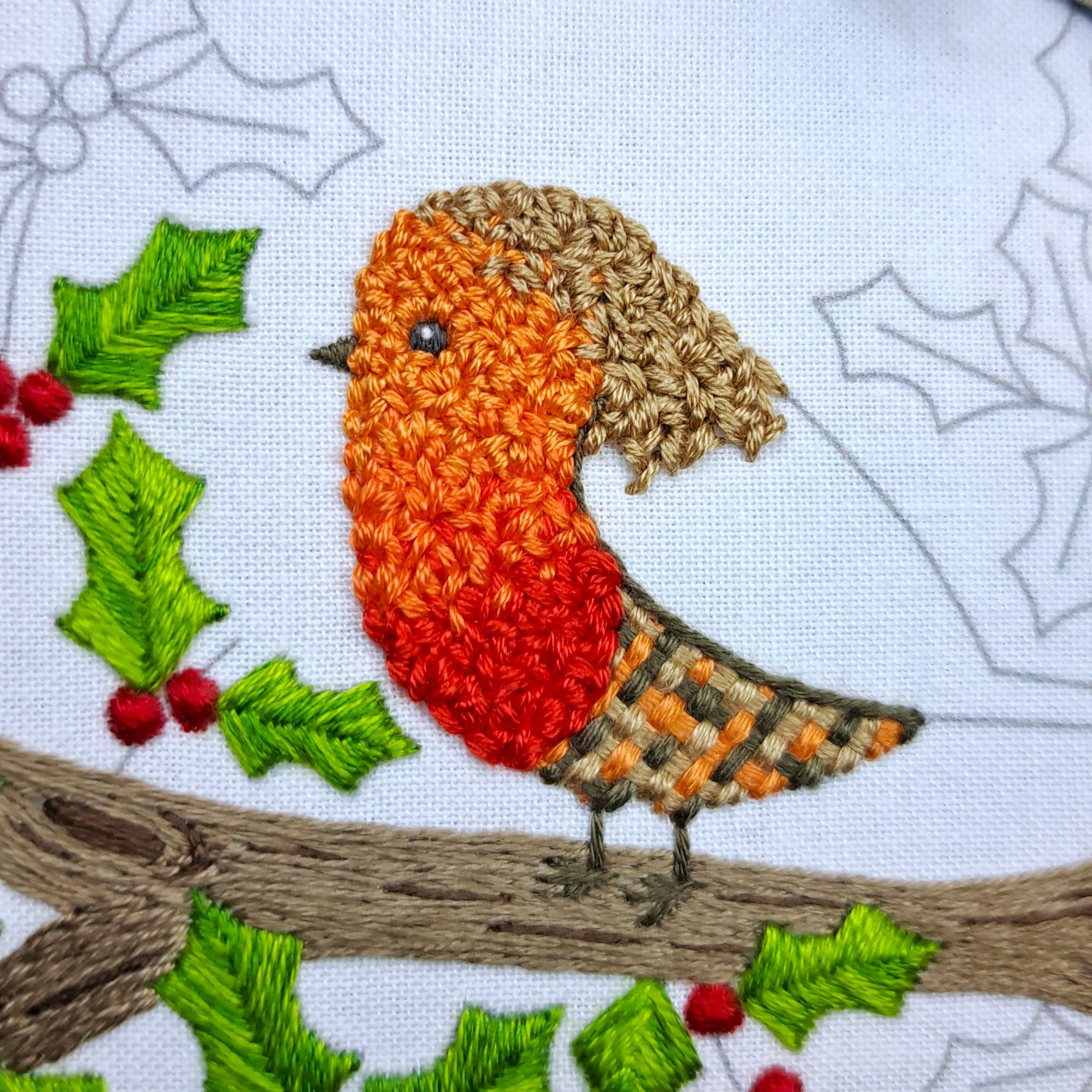 Close-up of partially stitched golden brown Loop Stitch on the robin’s head, back, and tail.