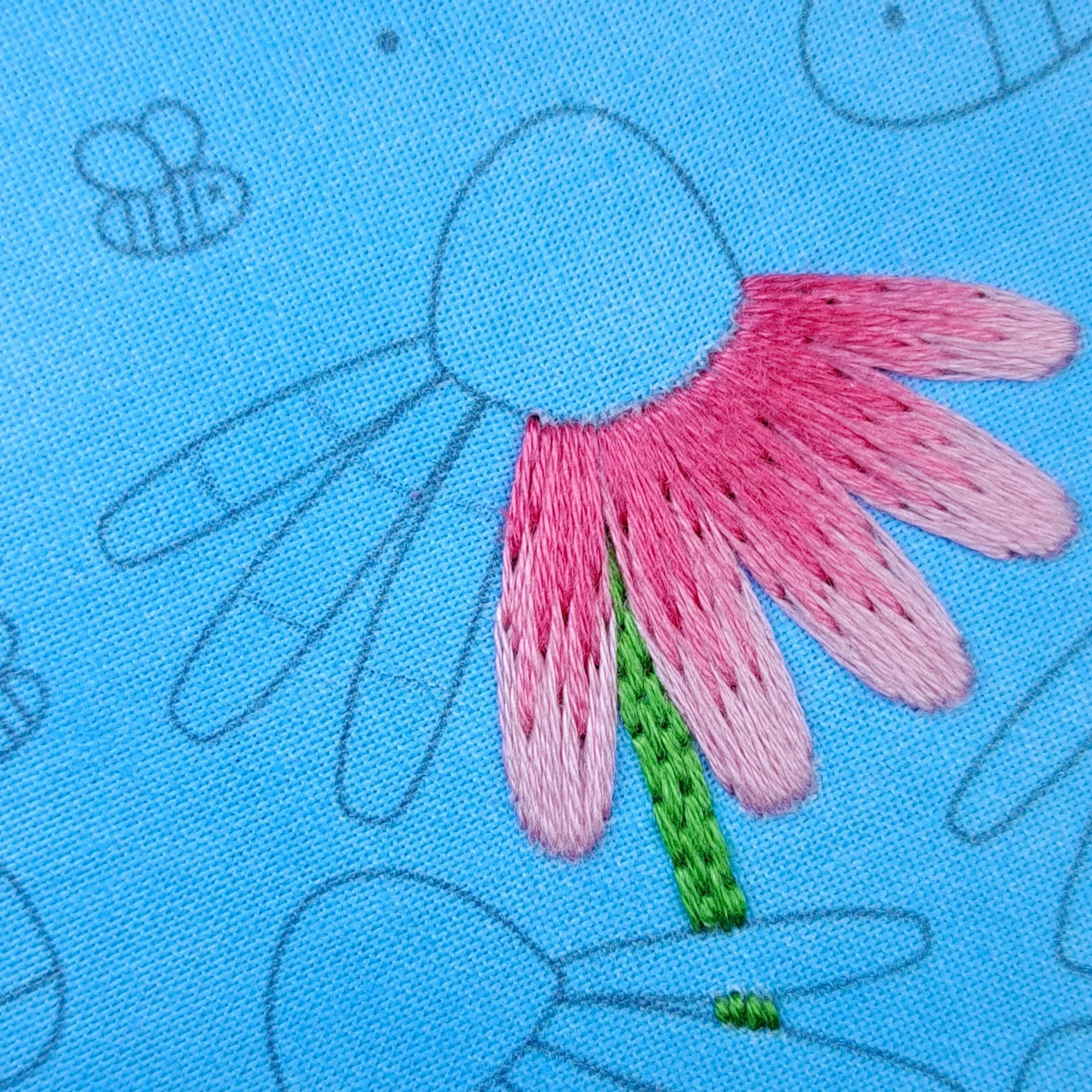 Close-up of the pink Satin Stitch used to embroider the inner sections of the middle Echinacea petals.