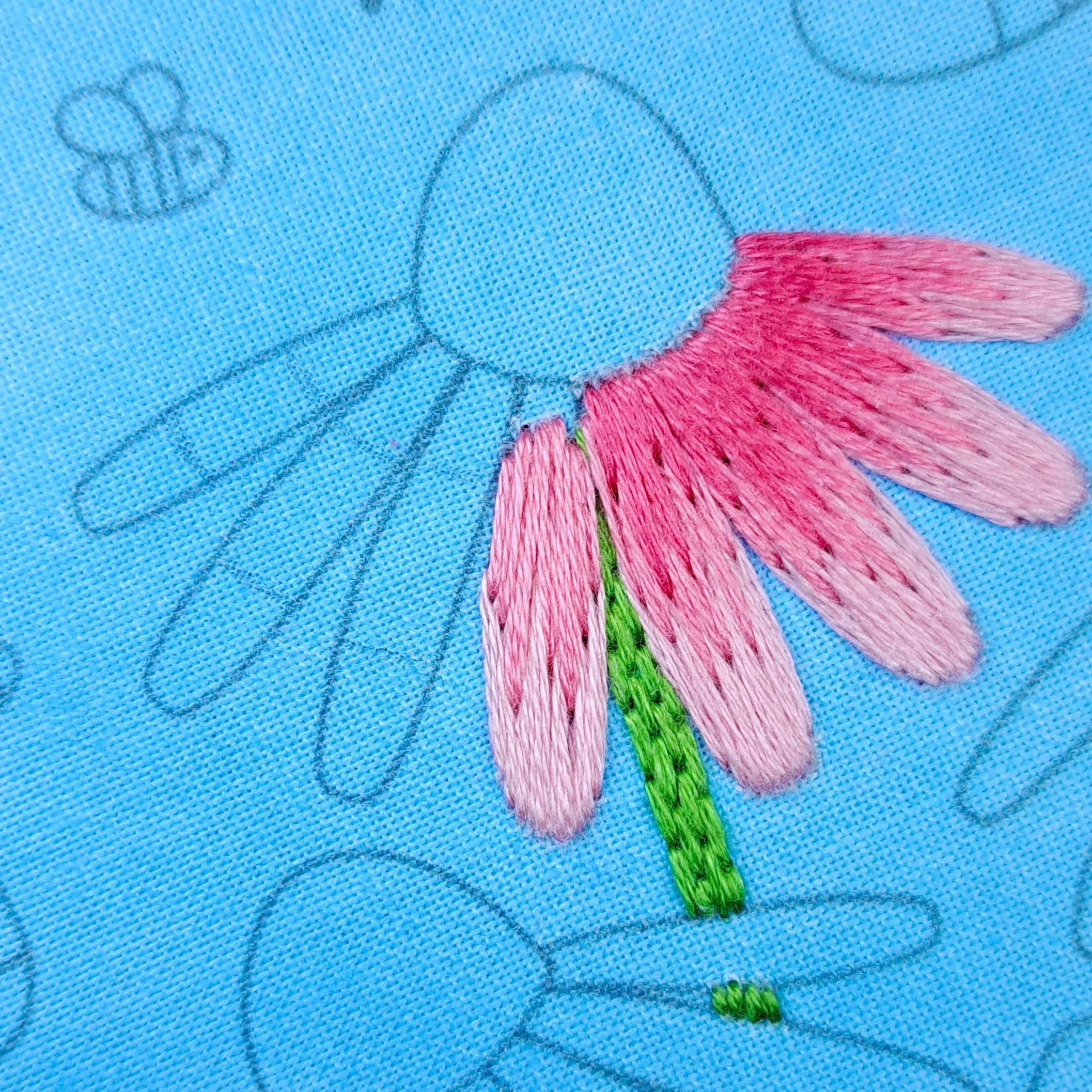 Close-up of the light pink Satin Stitch used to embroider the middle sections of the middle Echinacea petals.