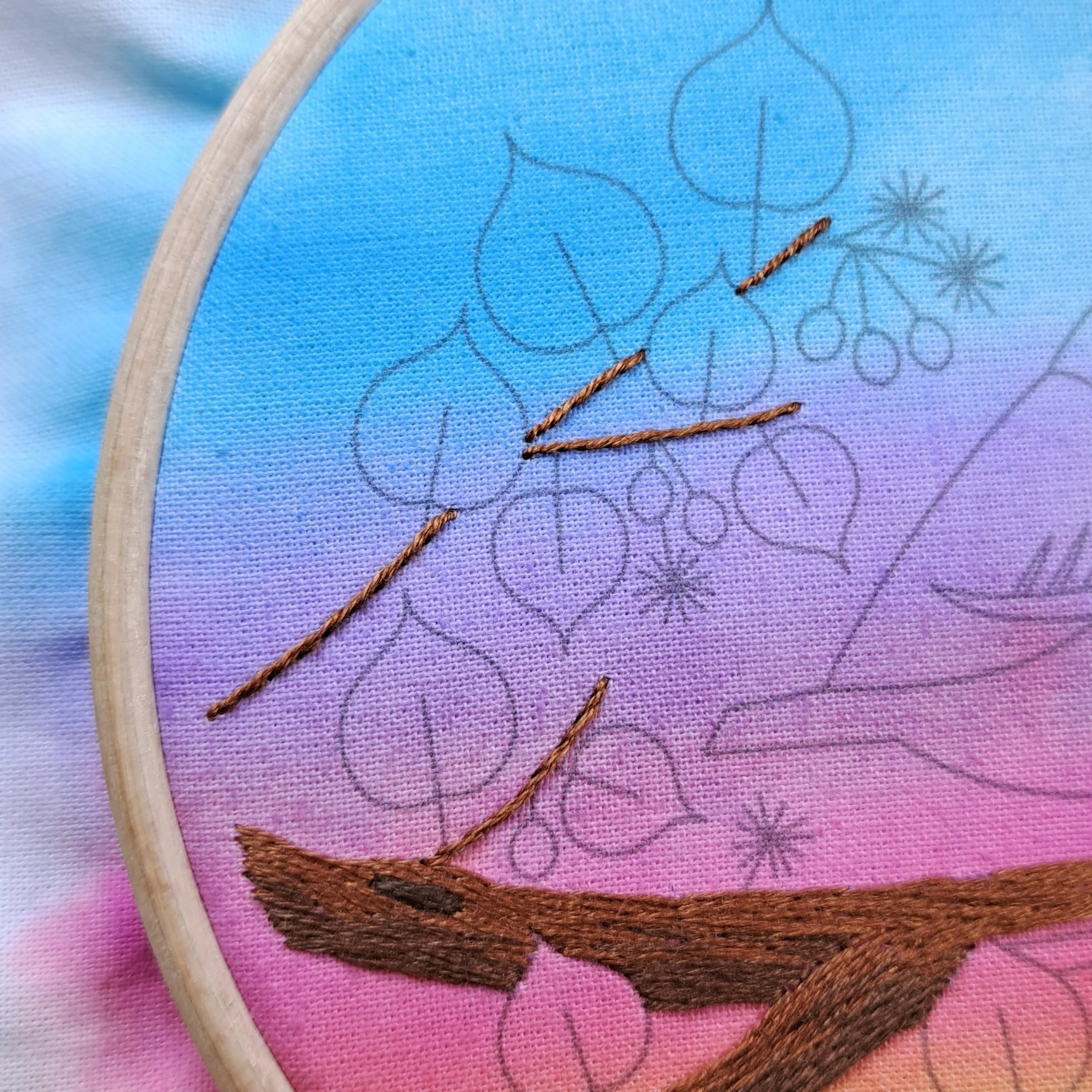 Close-up of the brown Stem Stitch used to embroider the twigs on the tree branch.