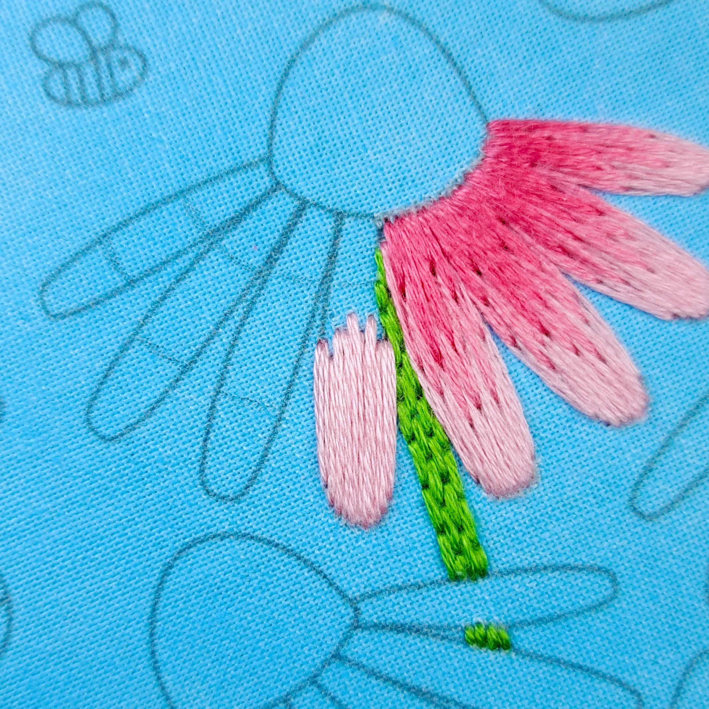 Close-up of the pale pink Satin Stitch used to embroider the outer sections of the middle Echinacea petals.