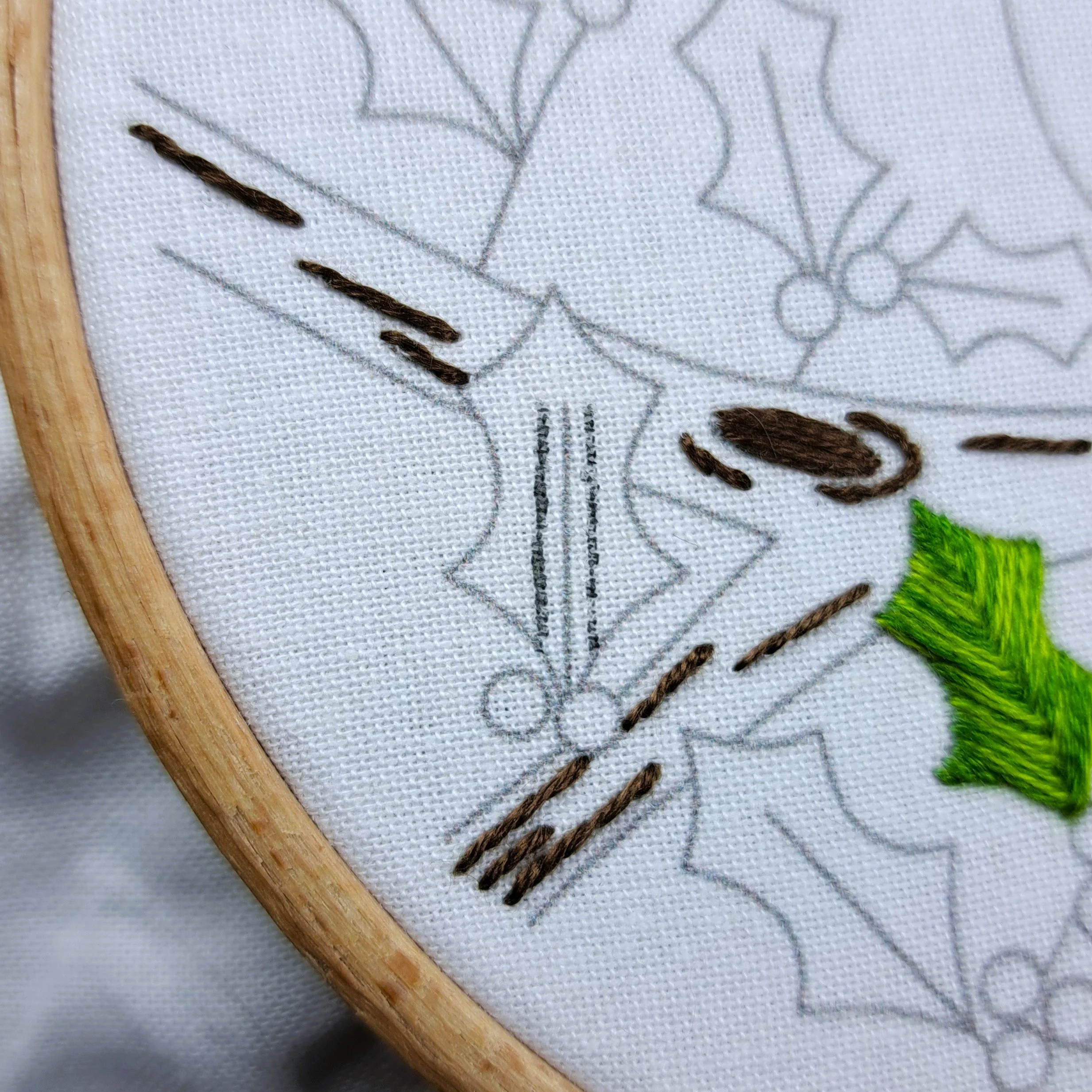 Unstitched holly leaf showing faint guiding lines for Fishbone Stitch.