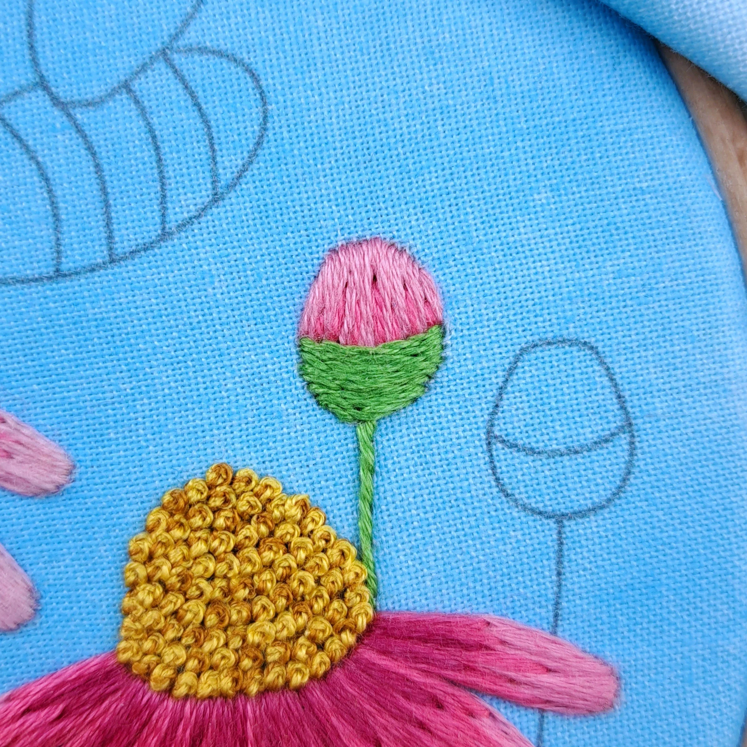 Close-up of the green Stem Stitches used to embroider the bottom part of a flower bud.