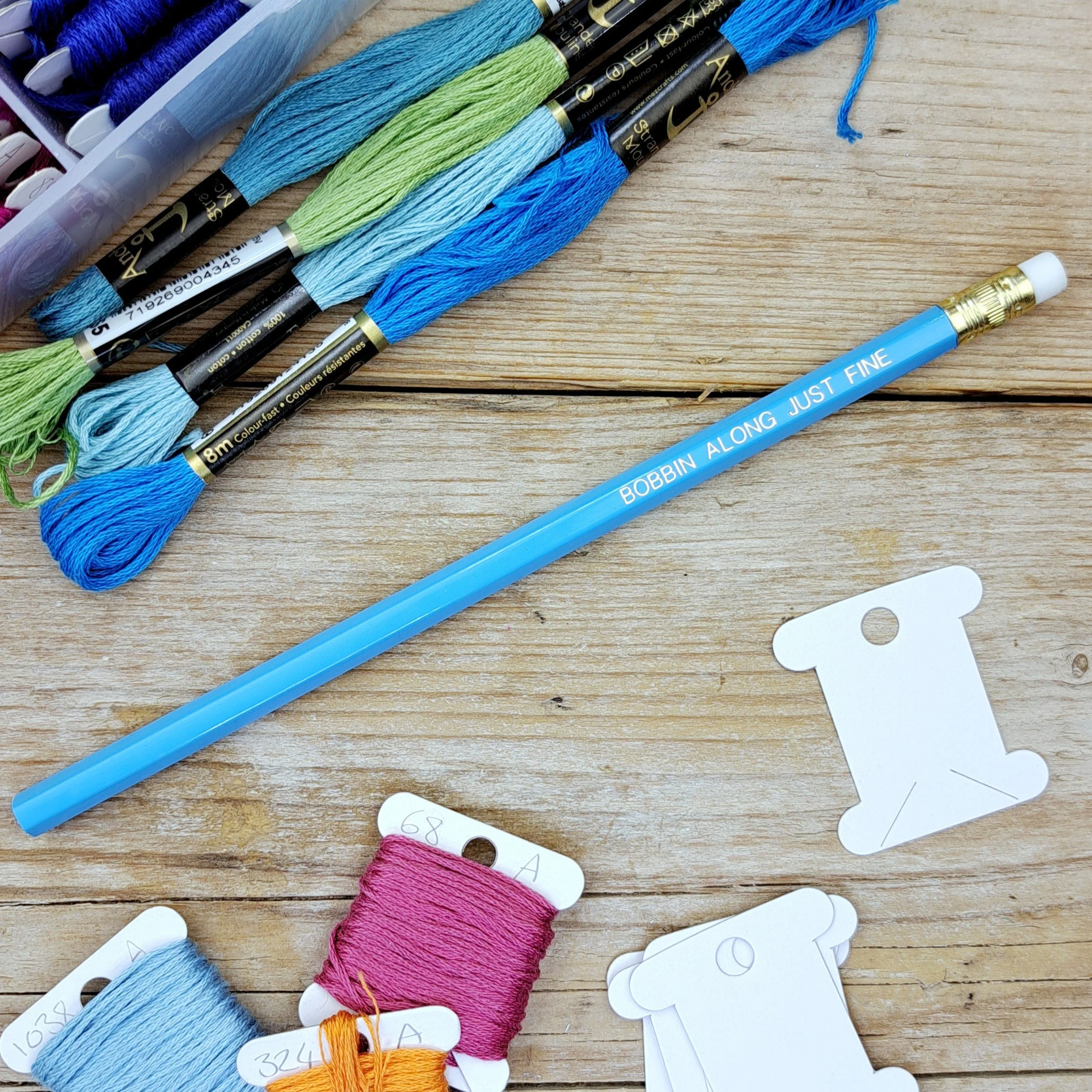 Full-length blue "Bobbin Along Just Fine" HB pencil with unsharpened graphite tip