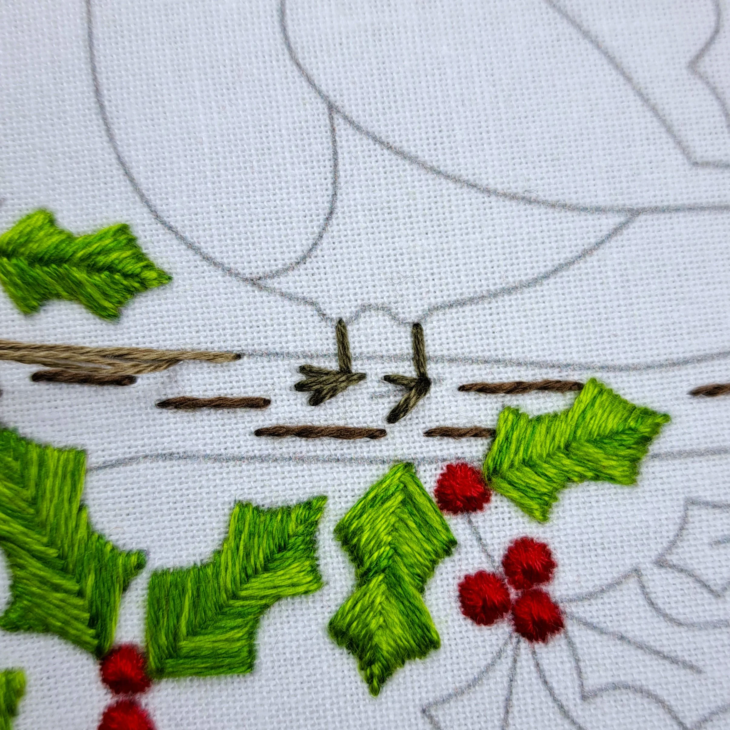 Close-up of the first brown Straight Stitches forming the robin’s leg.