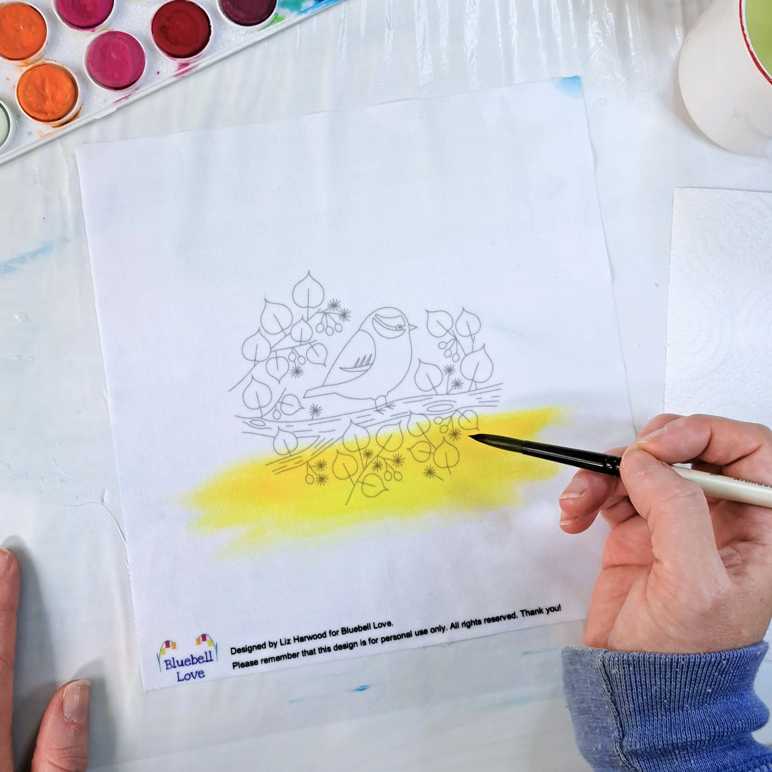 My hand painting the first colour band of sunrise to the fabric embroidery panel. I started with a band of yellow paint at the bottom of the design.