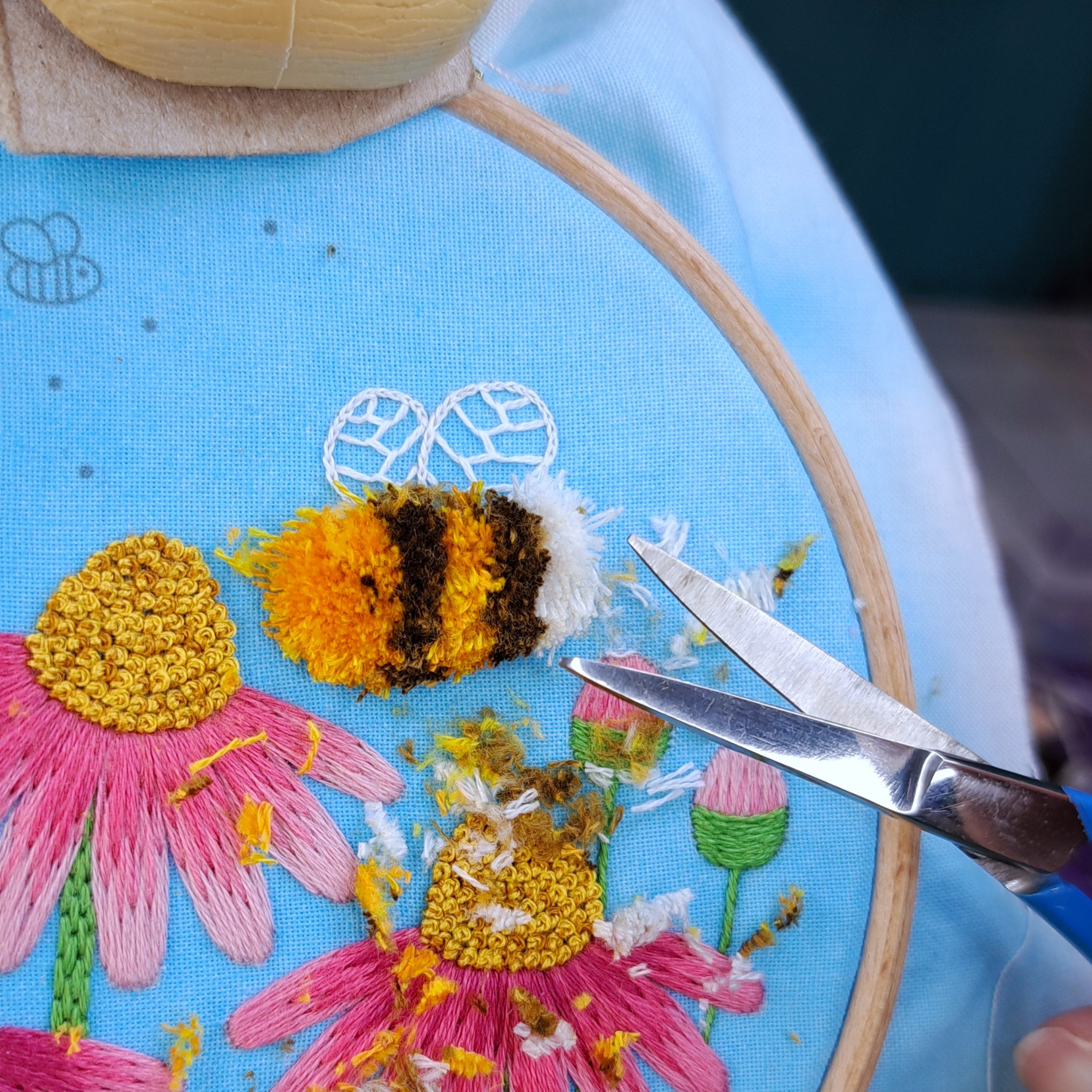 Close-up of the Turkey Stitch being trimmed into shape to form the bees body.