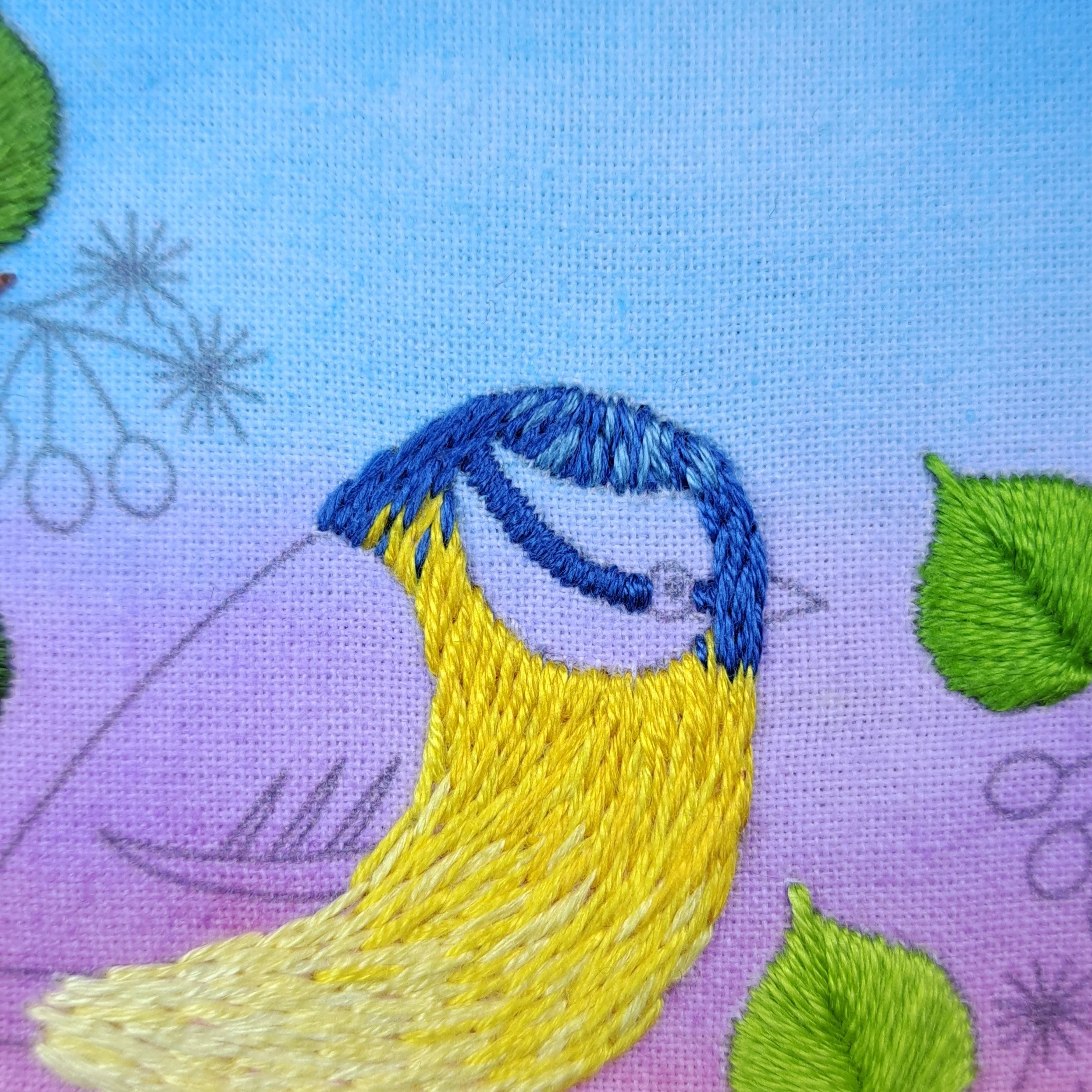 Close-up of the blue Long and Short Stitch and Satin Stitch used to embroider the feathers on the Blue Tits head.