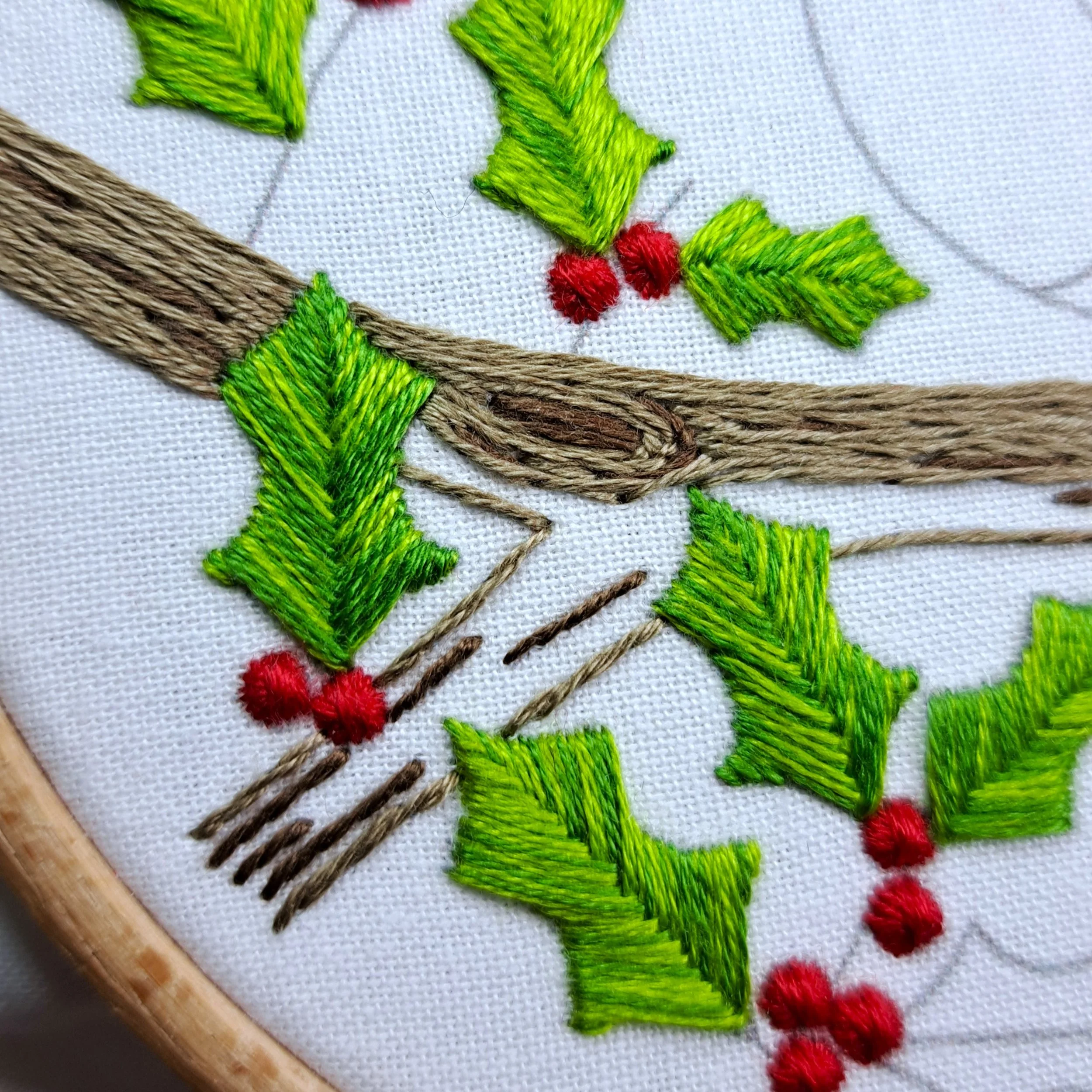 Close-up of brown Stem Stitch on the tree branch, stitched around the knots.
