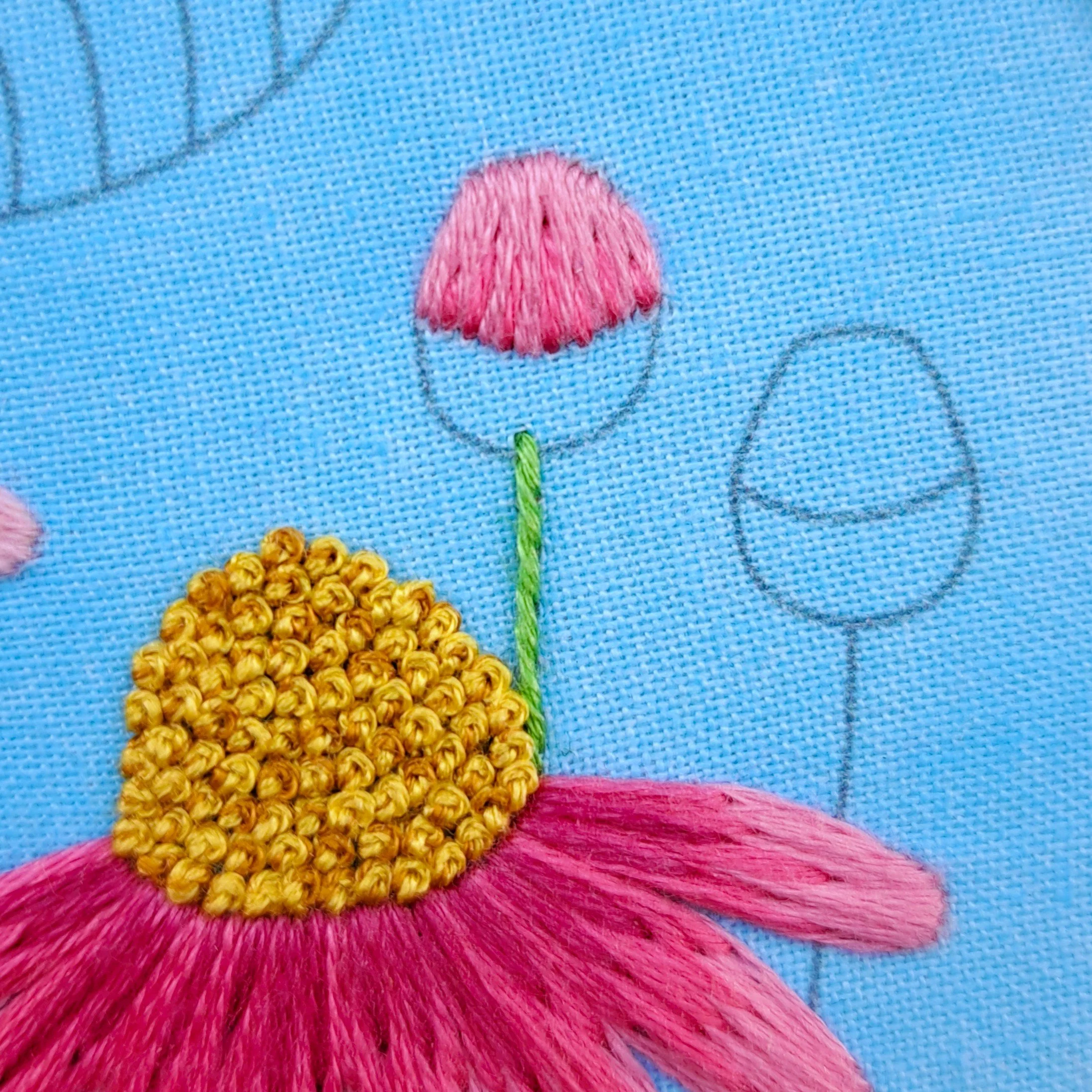 Close-up of the green Stem Stitch used to embroider the flower bud stems.