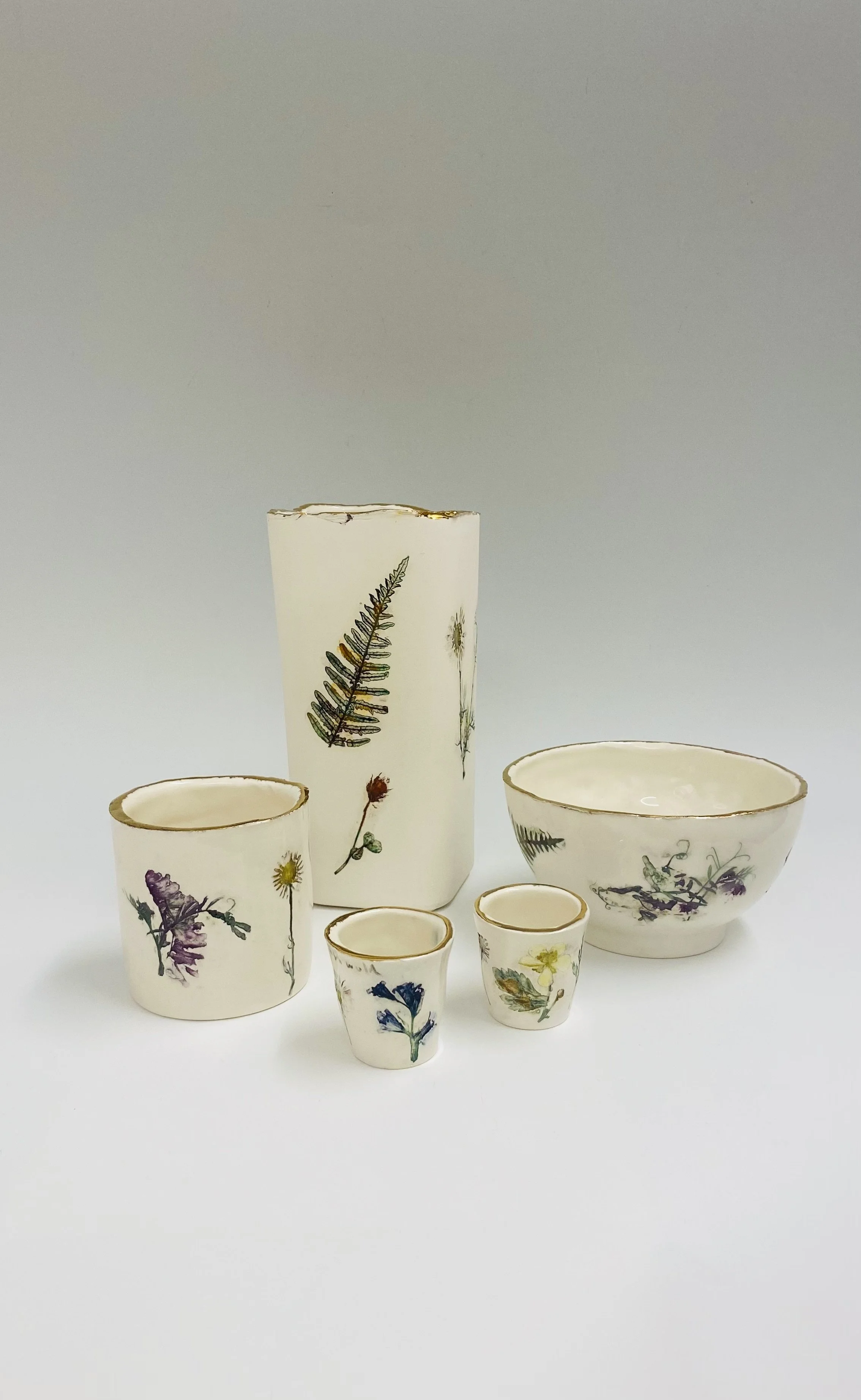 We are delighted to show Felicity Jones' new 'Covehithe' collection for autumn. Hand made porcelain ceramic with embossed intaglio of local wild flowers and hand painted gold trim. Shown here from left to right, 'Covehithe Wild Flower Tealight Holder