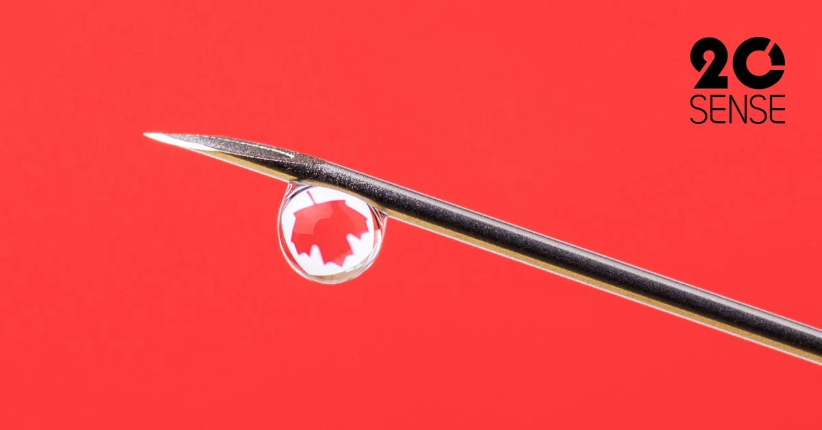 Close-up of needle with Canadian maple leaf in the droplet of medicine