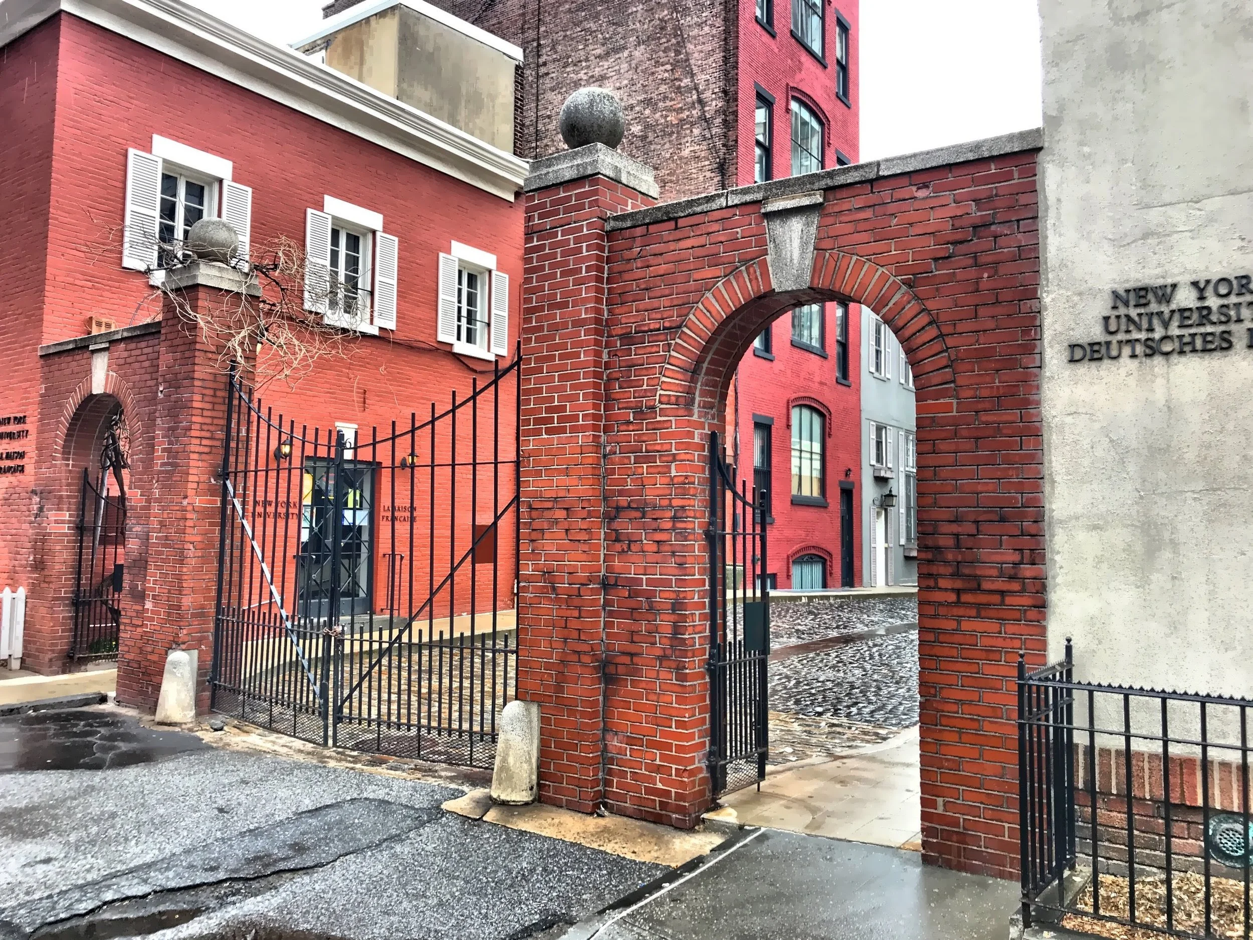  Pictured here is the gate of Washington Mews, a gated walkway that captures the magic of the area, with a street of converted two-story carriage houses. 
