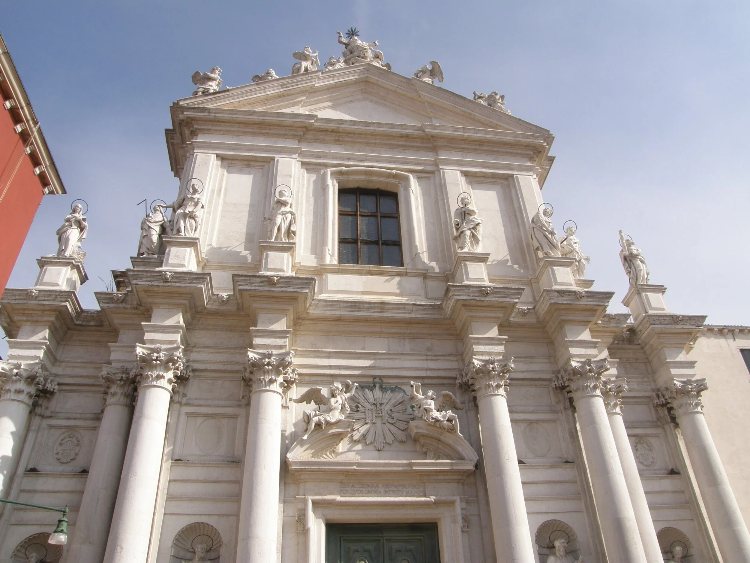  This is the facade of the Church of Santa Maria, with columns, each one supporting a statue. 