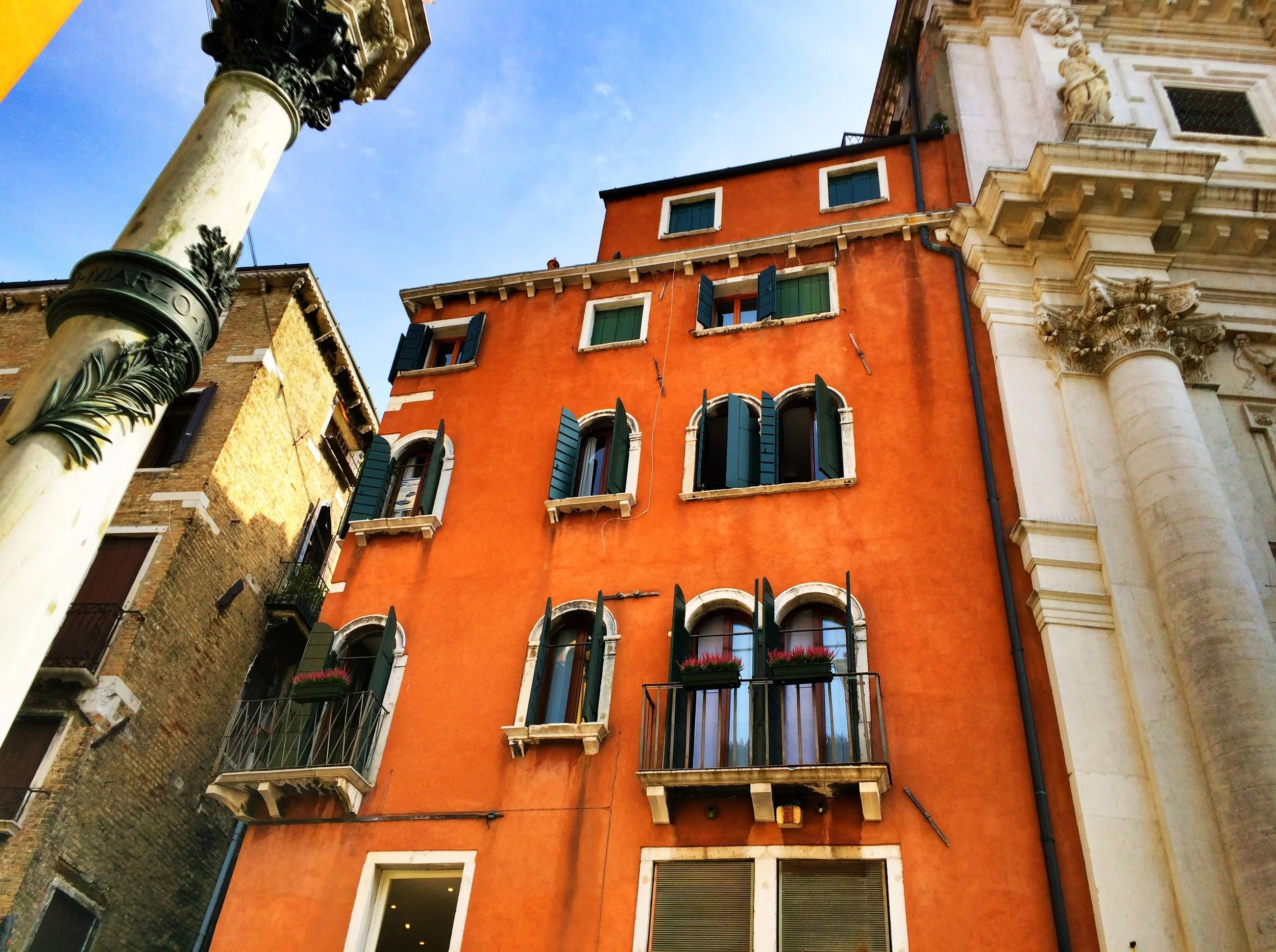  Balconies with wrought iron and arched windows with shutters 