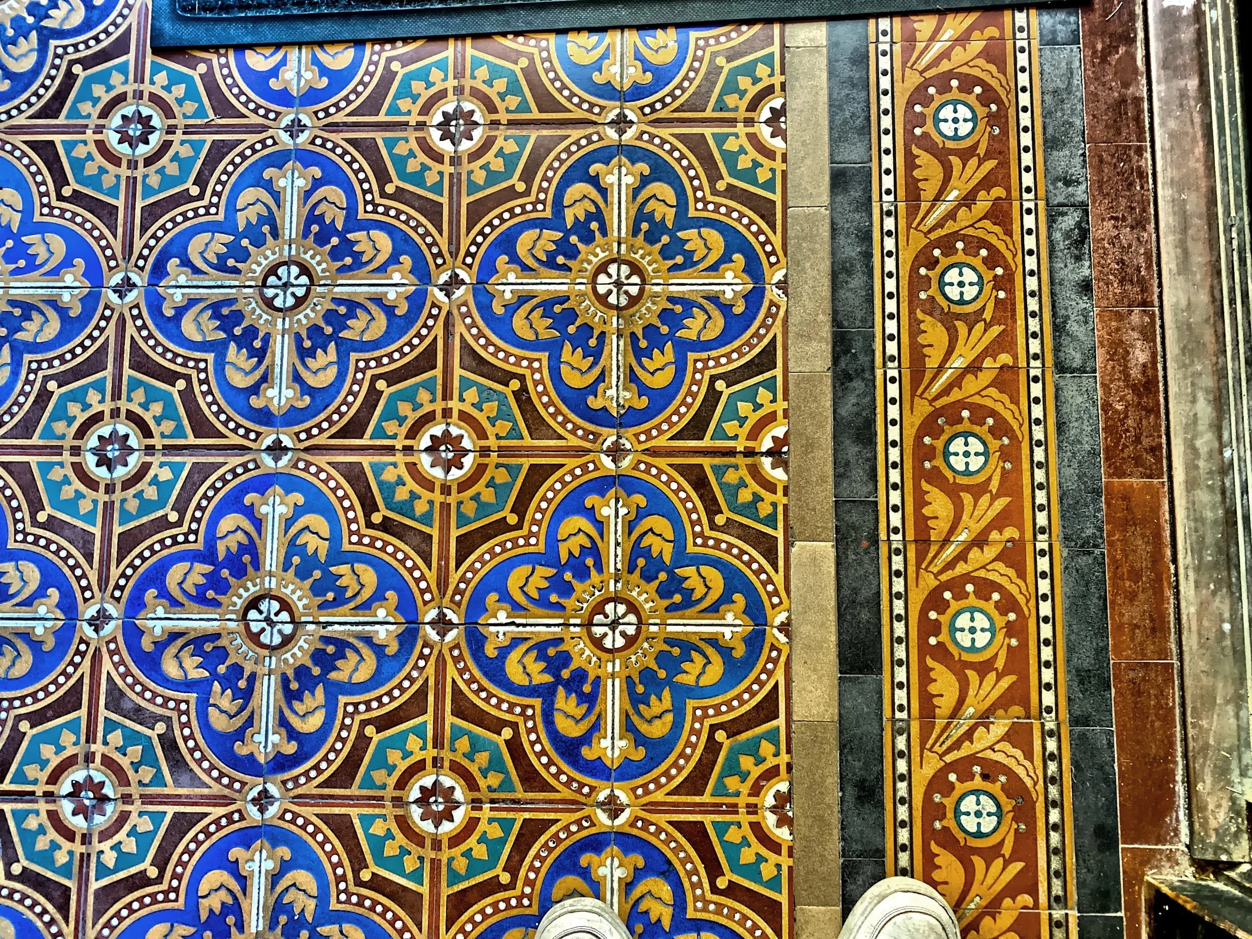  Here is the beautiful original English floor tile by Maw and Co. in the vestibule and Great Hall.  The lively design includes geometric and flower patterns. 