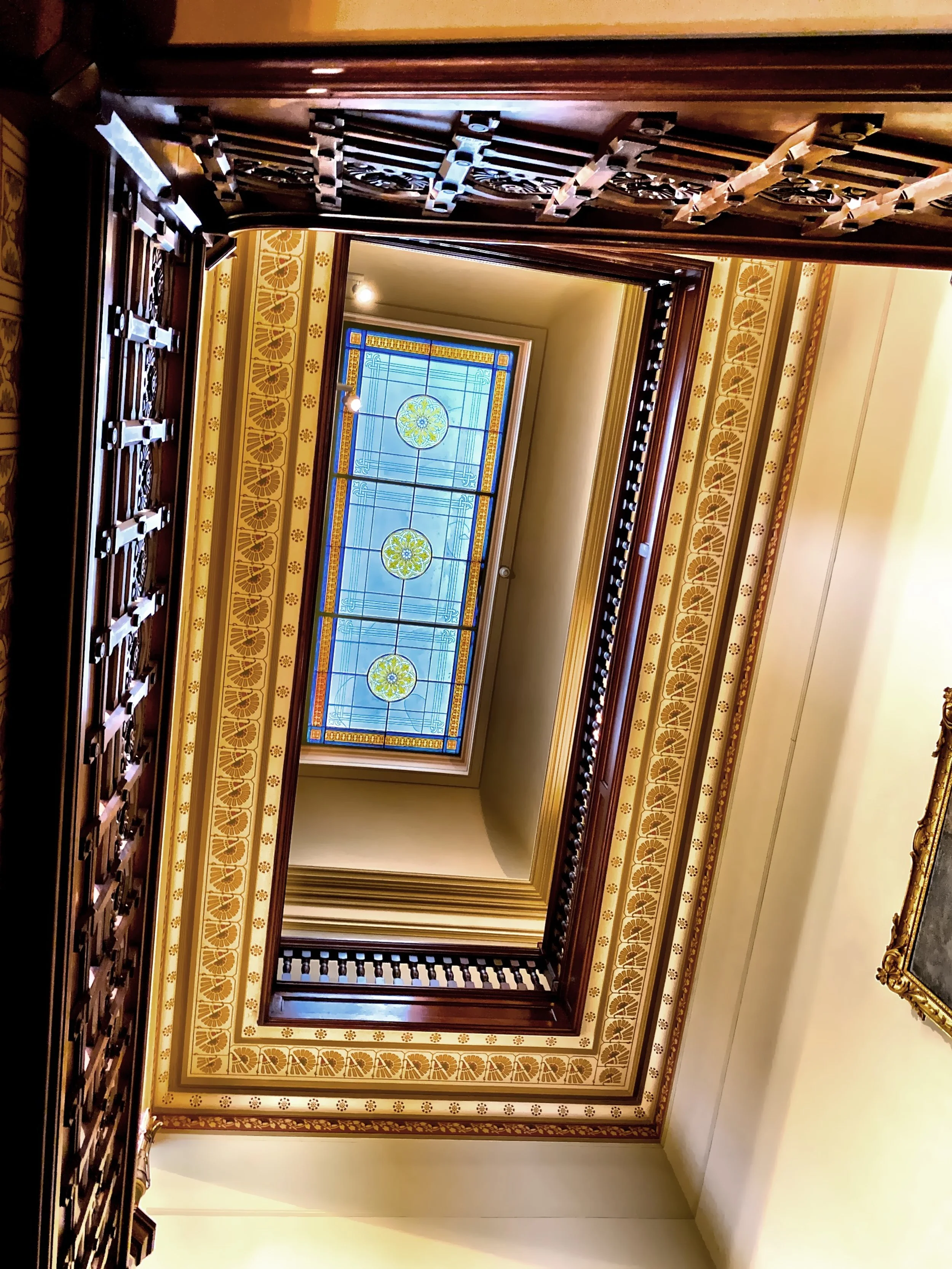  Looking up the staircase, you can see the balustraded levels which housed the family’s bedrooms, and the stained glass laylight. 