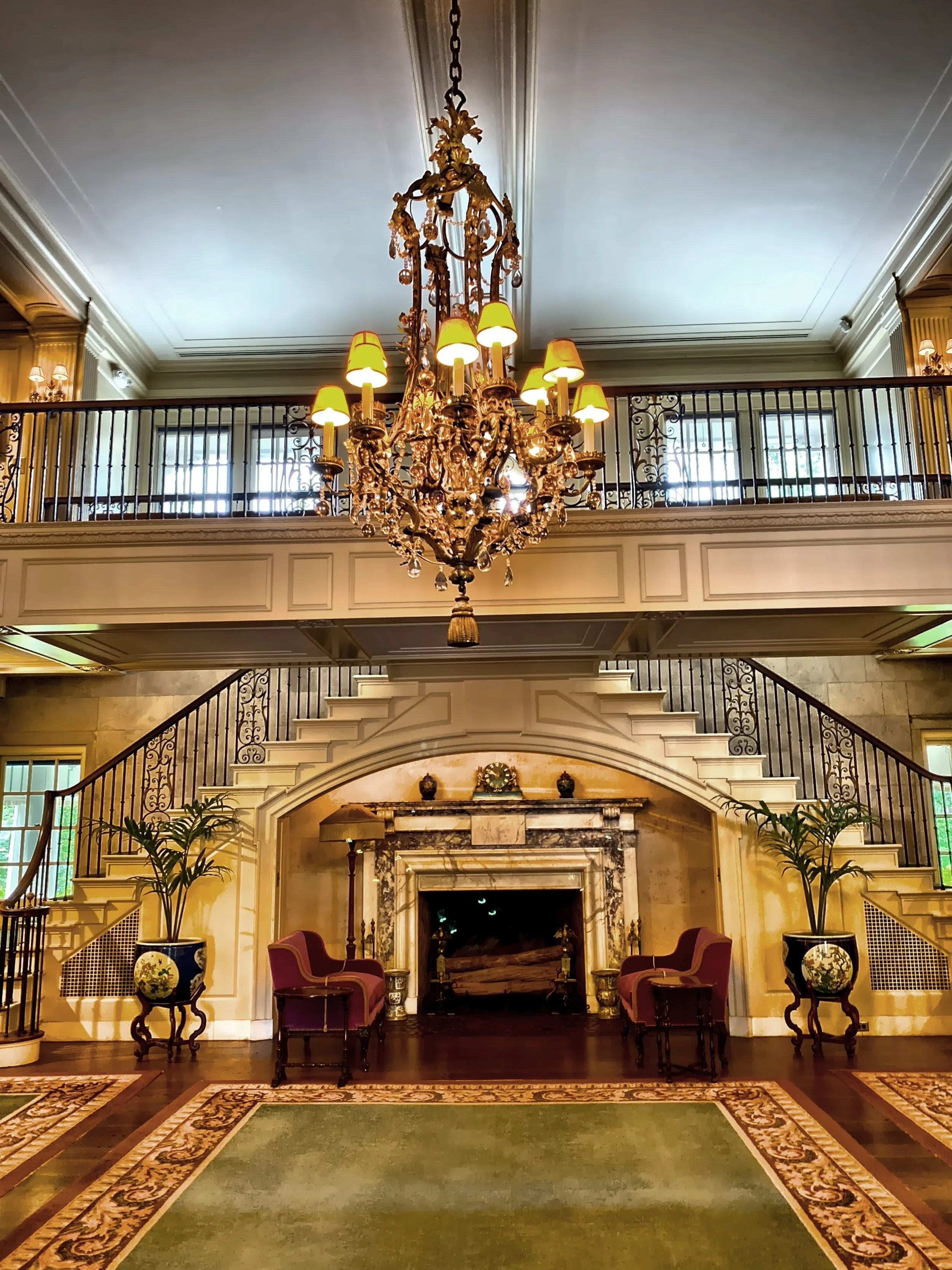  The dual staircase framing the fireplace in the reception hall 