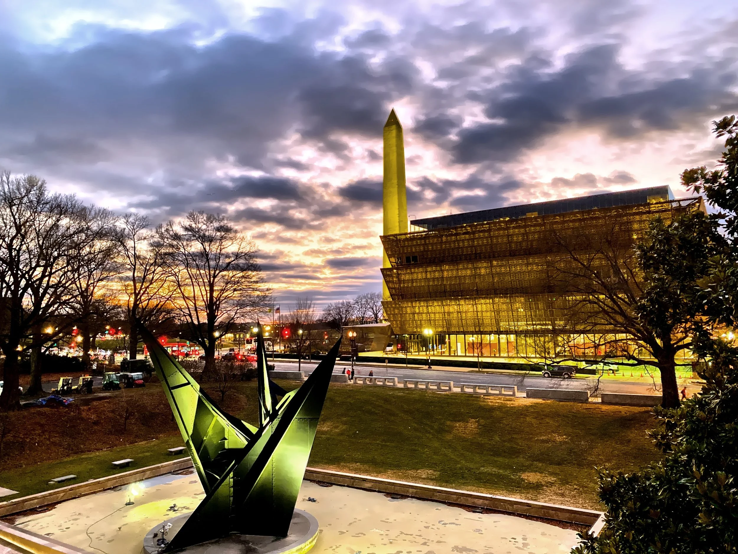  A colorful sunset is the backdrop for the Washington Monument and National Museum of African American History &amp; Culture 