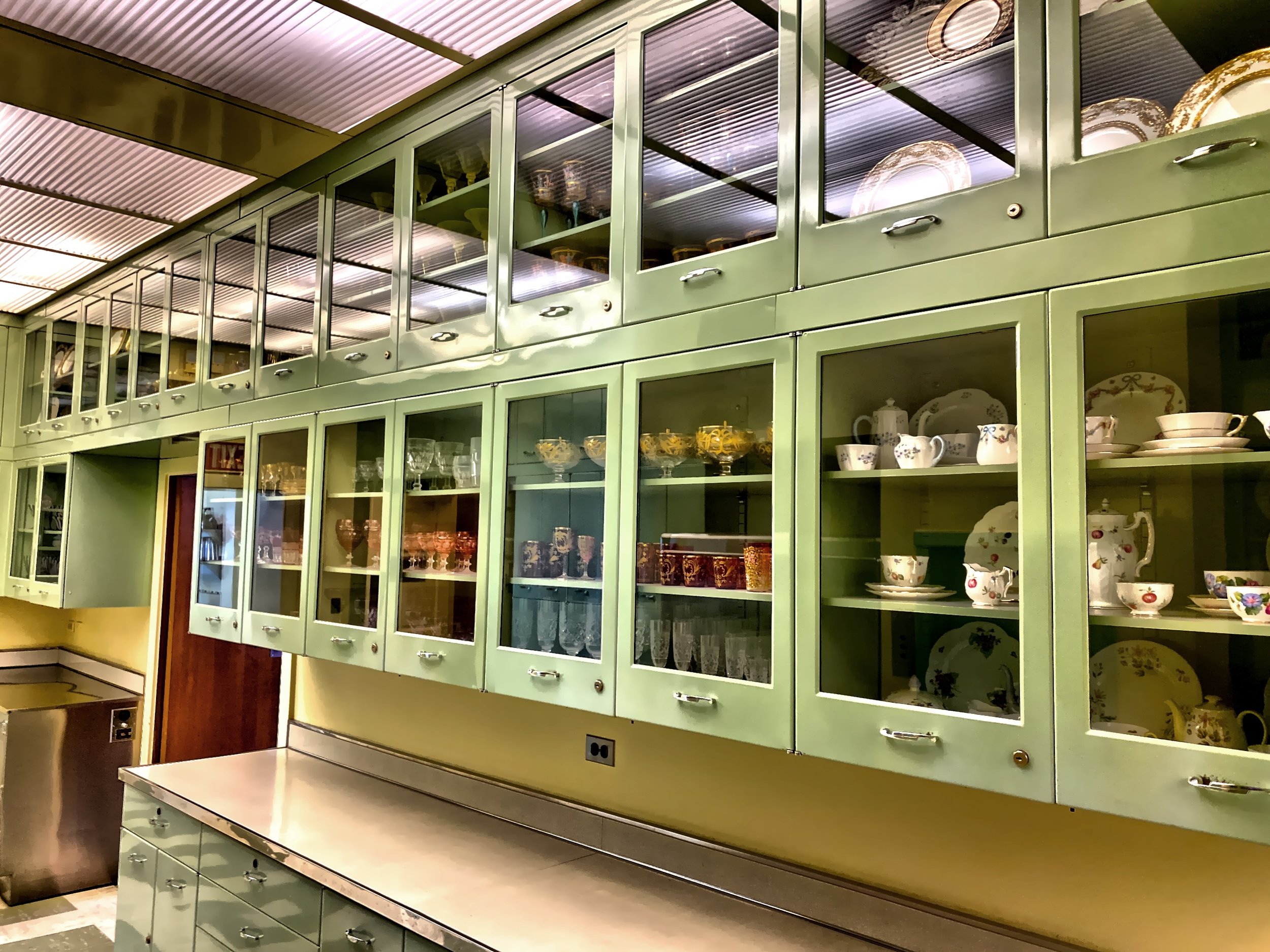  Many cabinets in the pantry, each holding a different service of china. 