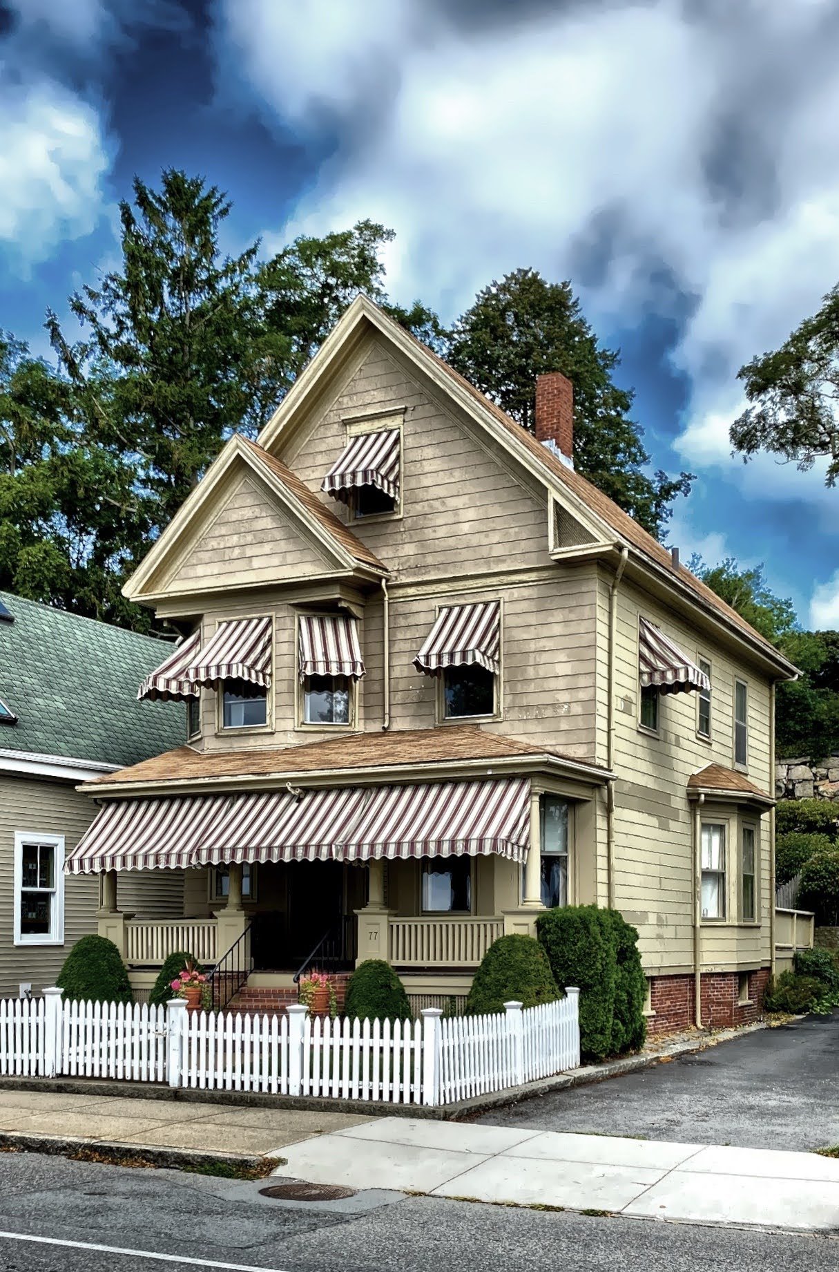  Clapboard house with large porch and awnings 