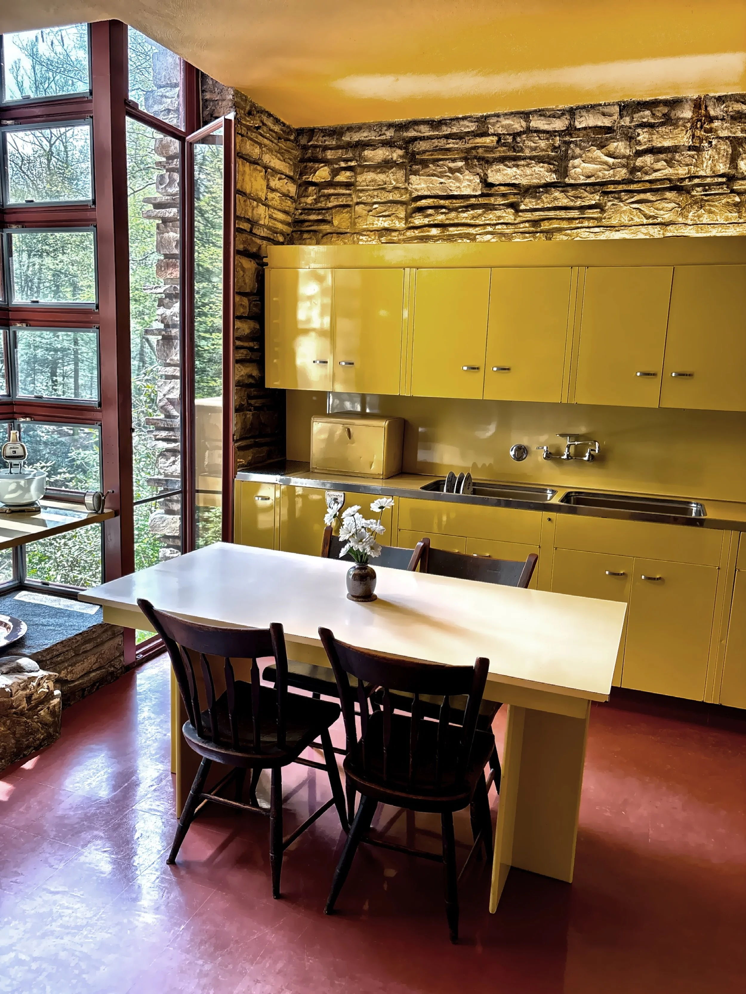  The kitchen was designed to be essentially utilitarian in nature and included steel cabinets, a Formica-topped work table and asphalt floor tiles. 