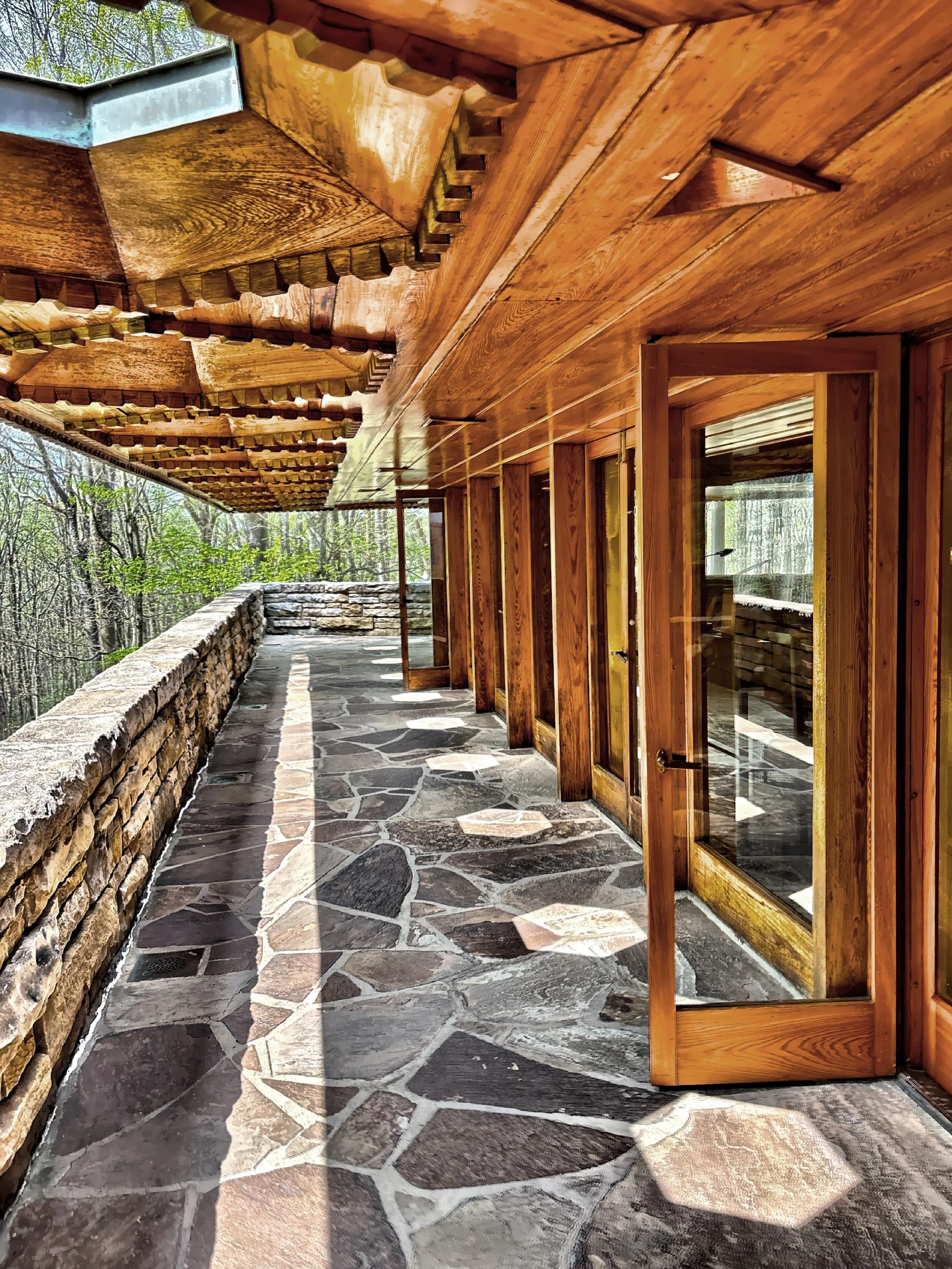  Sunlight coming through the honeycomb-shaped skylights on the rear porch, which is accessed through a series of French doors. 