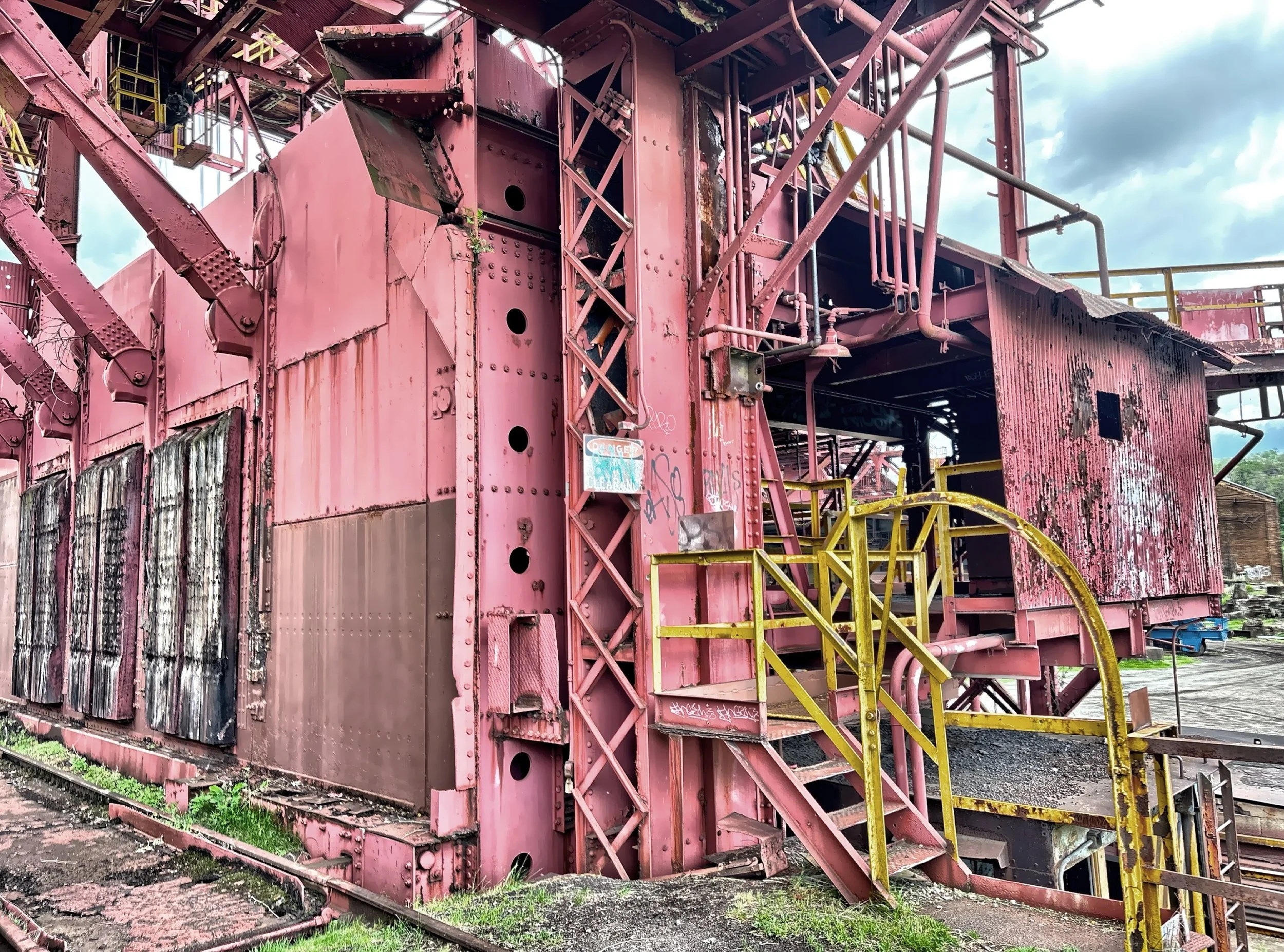  The site includes remnants of the raw materials handling systems like ore bins and hoists. 