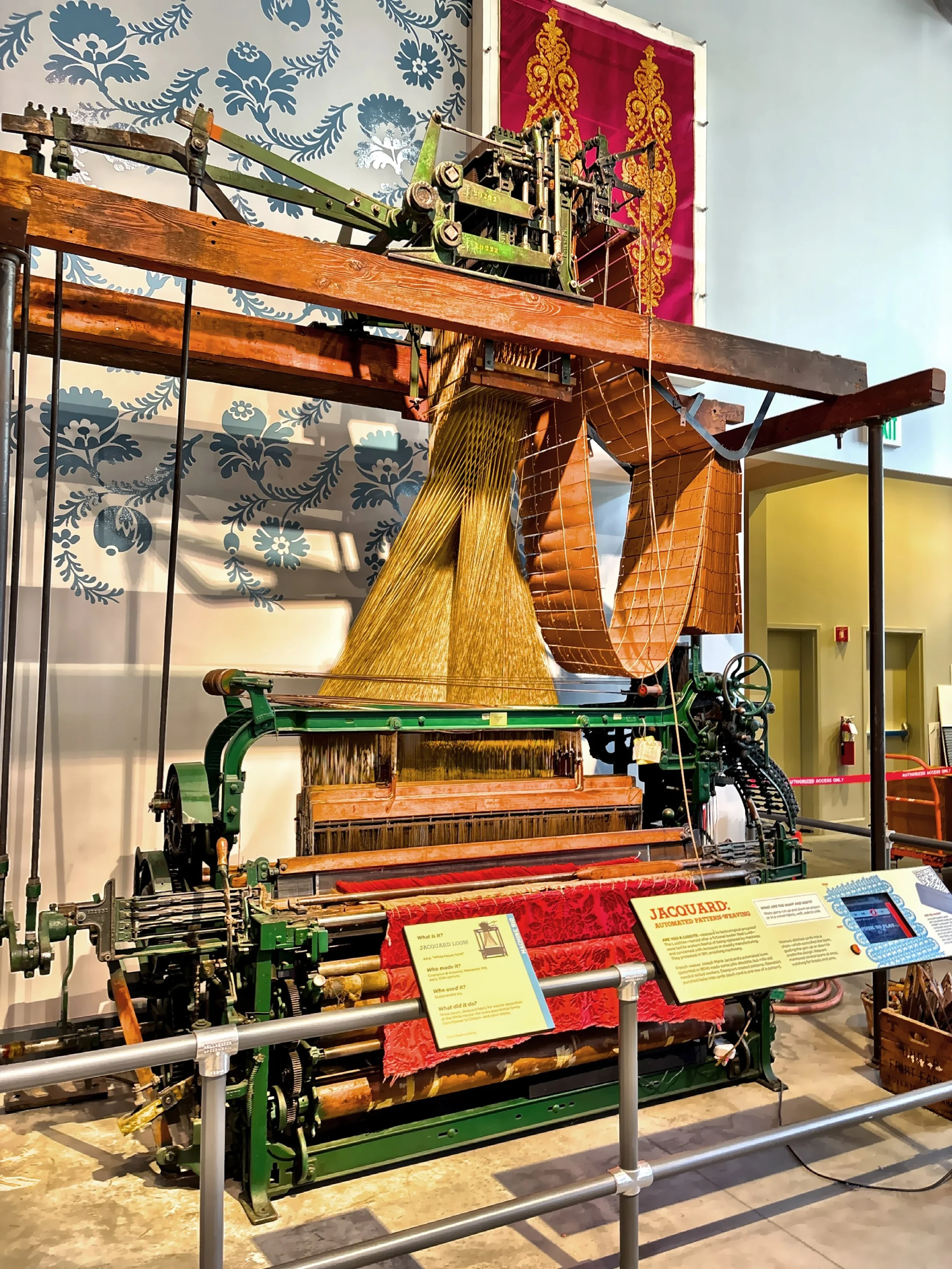  A jacquard Loom is one of the numerous looms and spinning wheels on display here. 