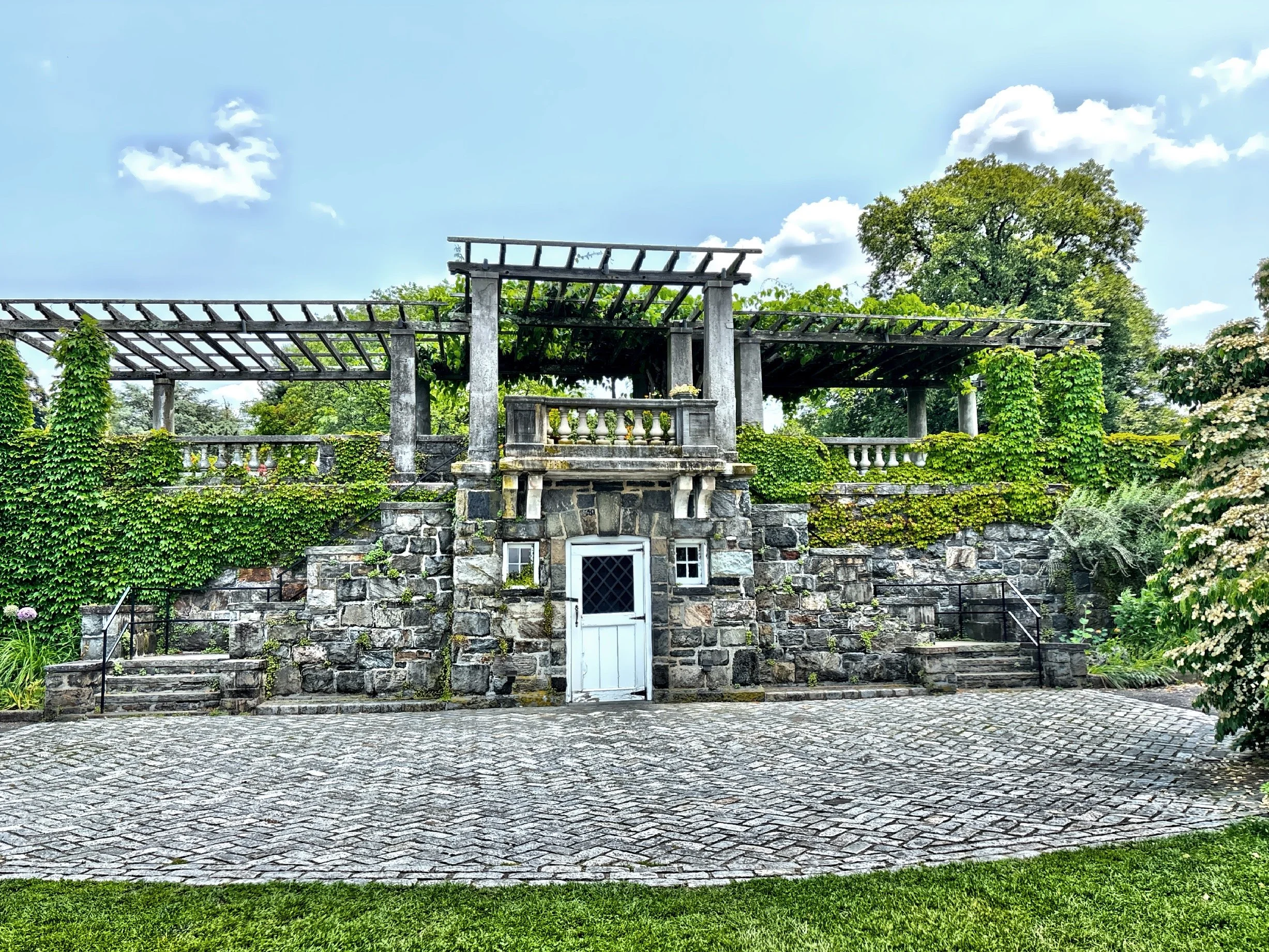  This is the entrance to a large, three-story underground recreation building, that was designed by Robert M. Byers in 1909.  It included a billiard room, bowling alley and a squash court, as well as a large Adirondack-style gathering room with a sto