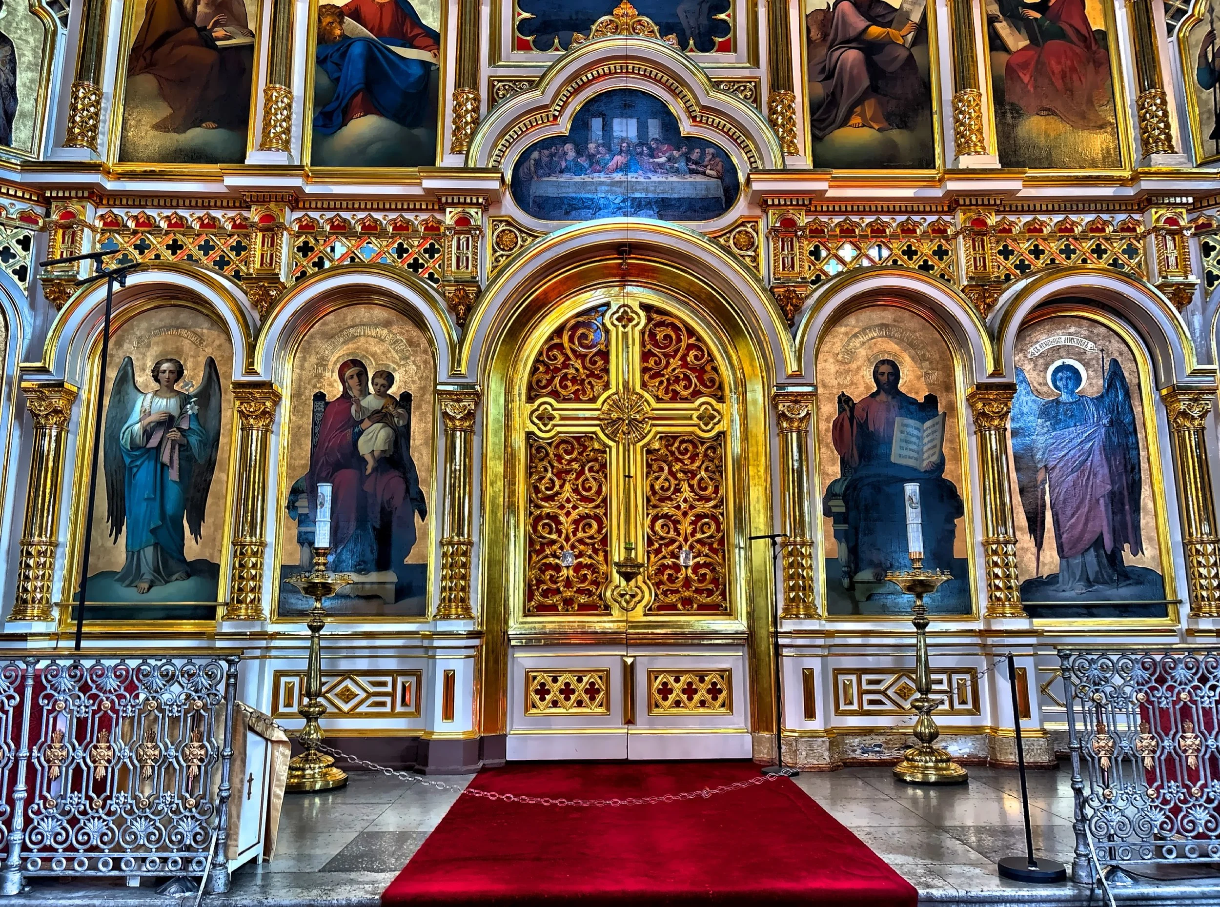  The richly decorated wall of icons and religious paintings. 