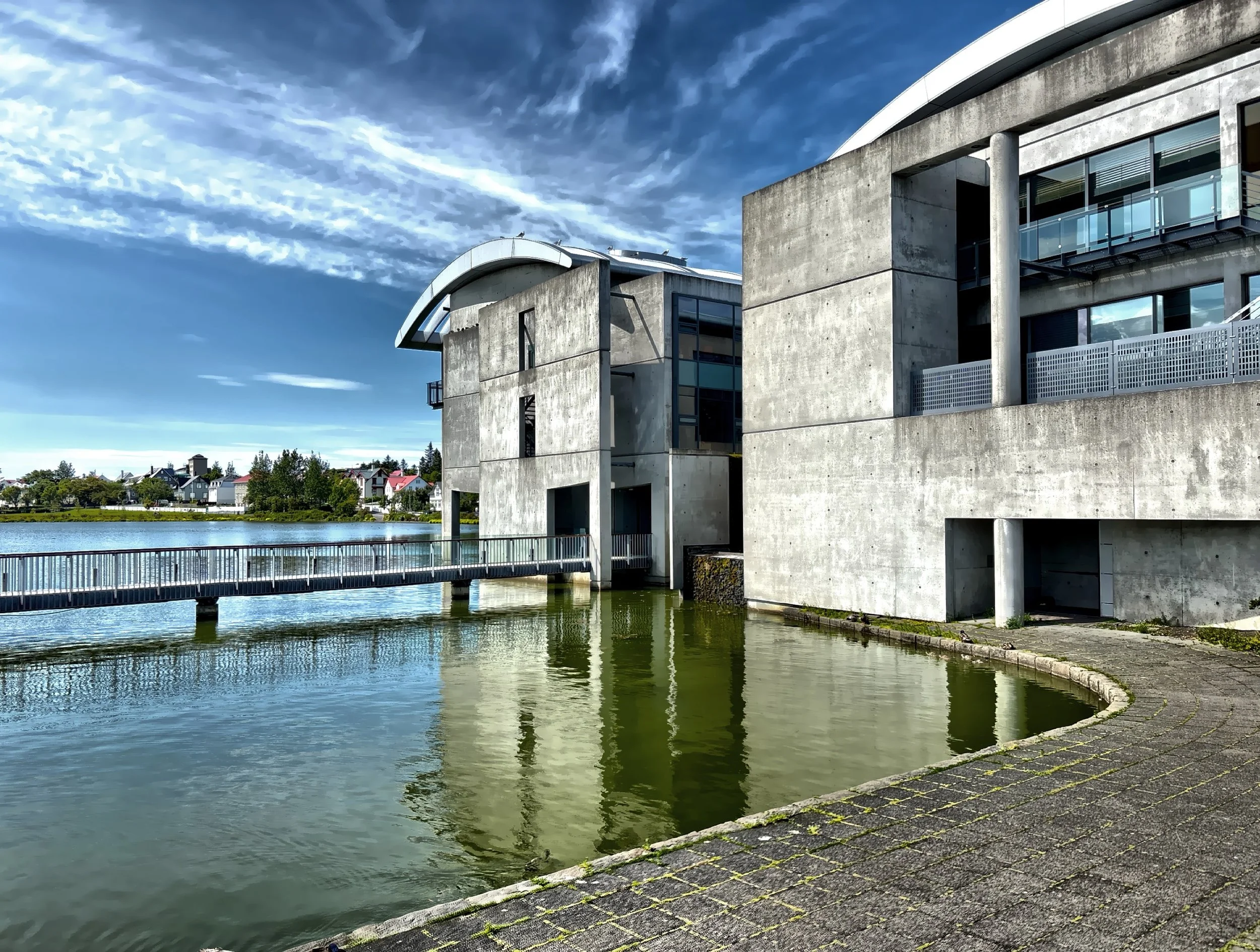  Reykjavik City Hall, designed by Studio Granada and completed in 1992, is a modern building situated on the shore of Tjornin pond. 