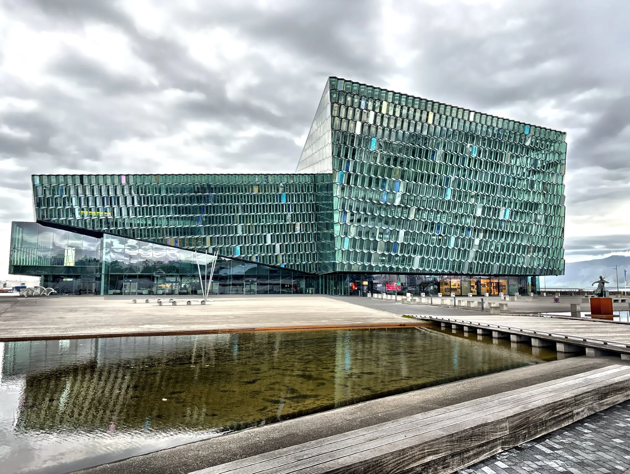  The shimmering facade of Harpa Concert Hall mirrors the ocean and sky.  The concert hall was opened in 2011. 