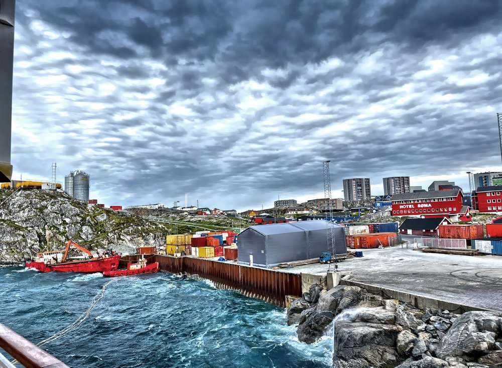  Rugged terrain with high rise building in the distance. 